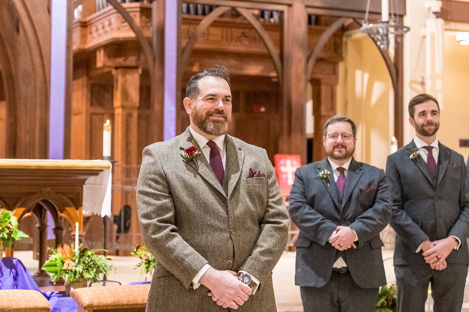 Groom and groomsmen waiting at the front of the sanctuary at Our Lady of the Assumption