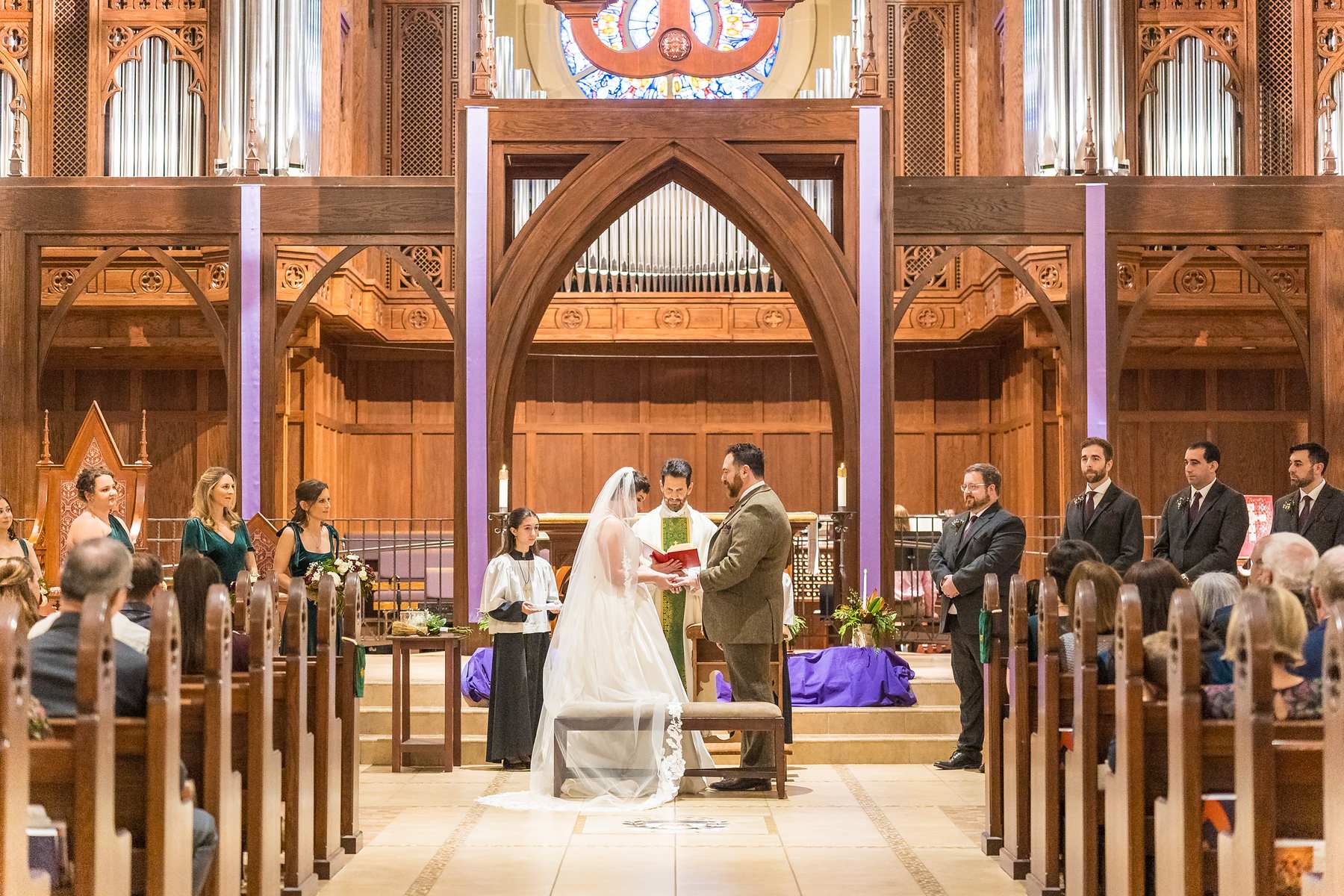 Couple exchanging vows at the altar of Our Lady of the Assumption Catholic Church in Atlanta