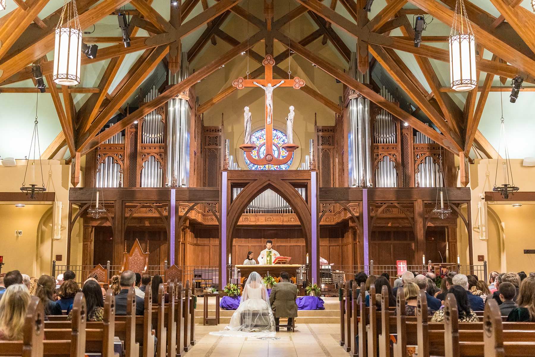 Wedding ceremony under the carved wood ceiling at Our Lady of the Assumption