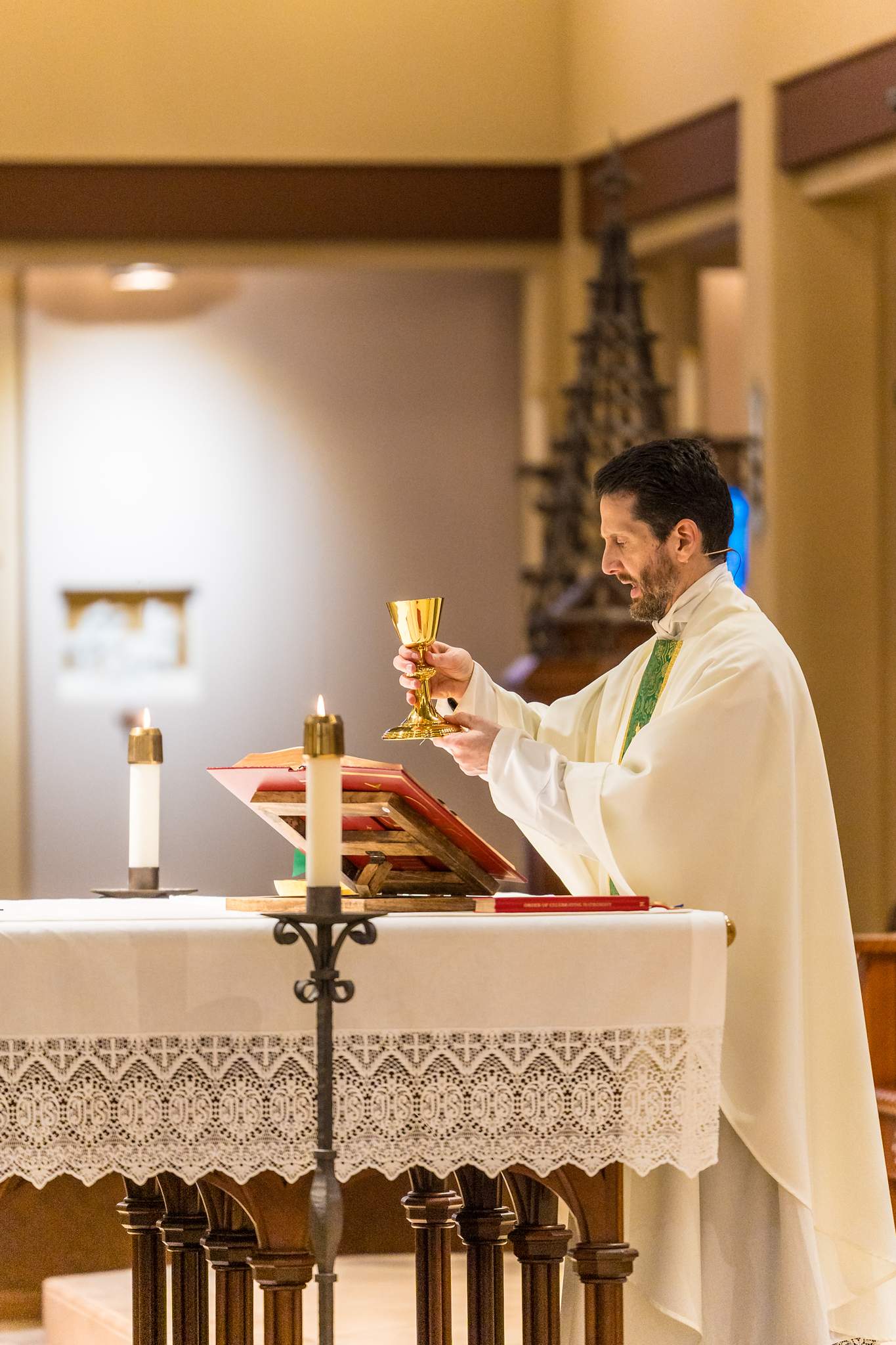 Priest raising the chalice during a Catholic wedding Mass