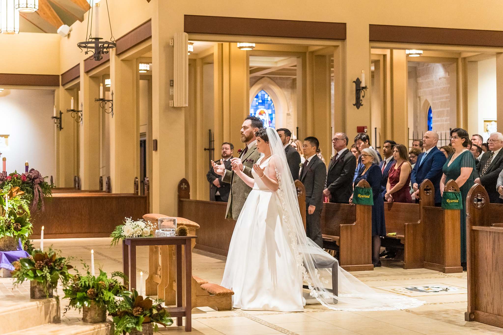 Couple standing at the altar during the liturgy at Our Lady of the Assumption
