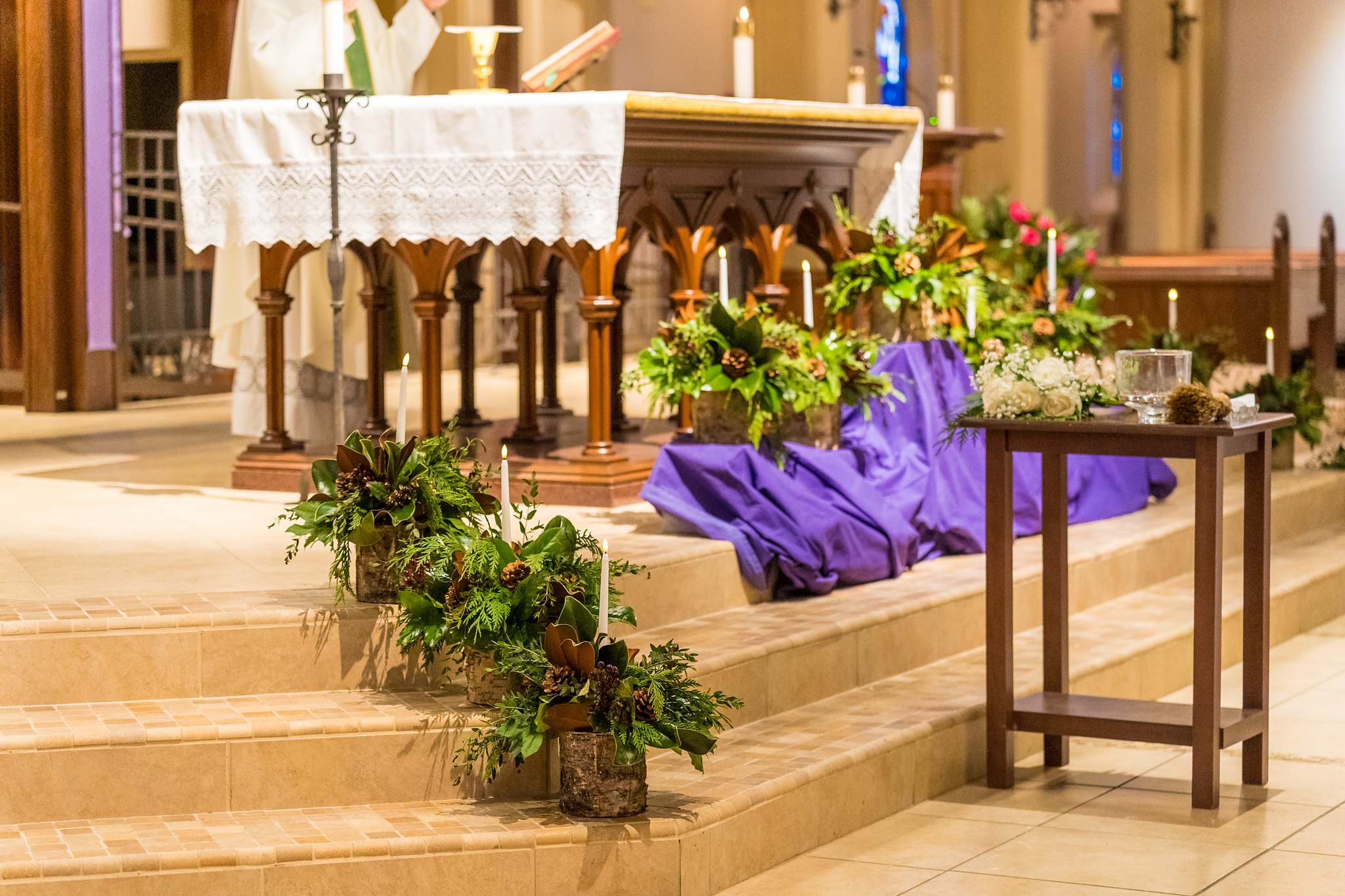 Altar decorated with greenery for a December wedding at Our Lady of the Assumption