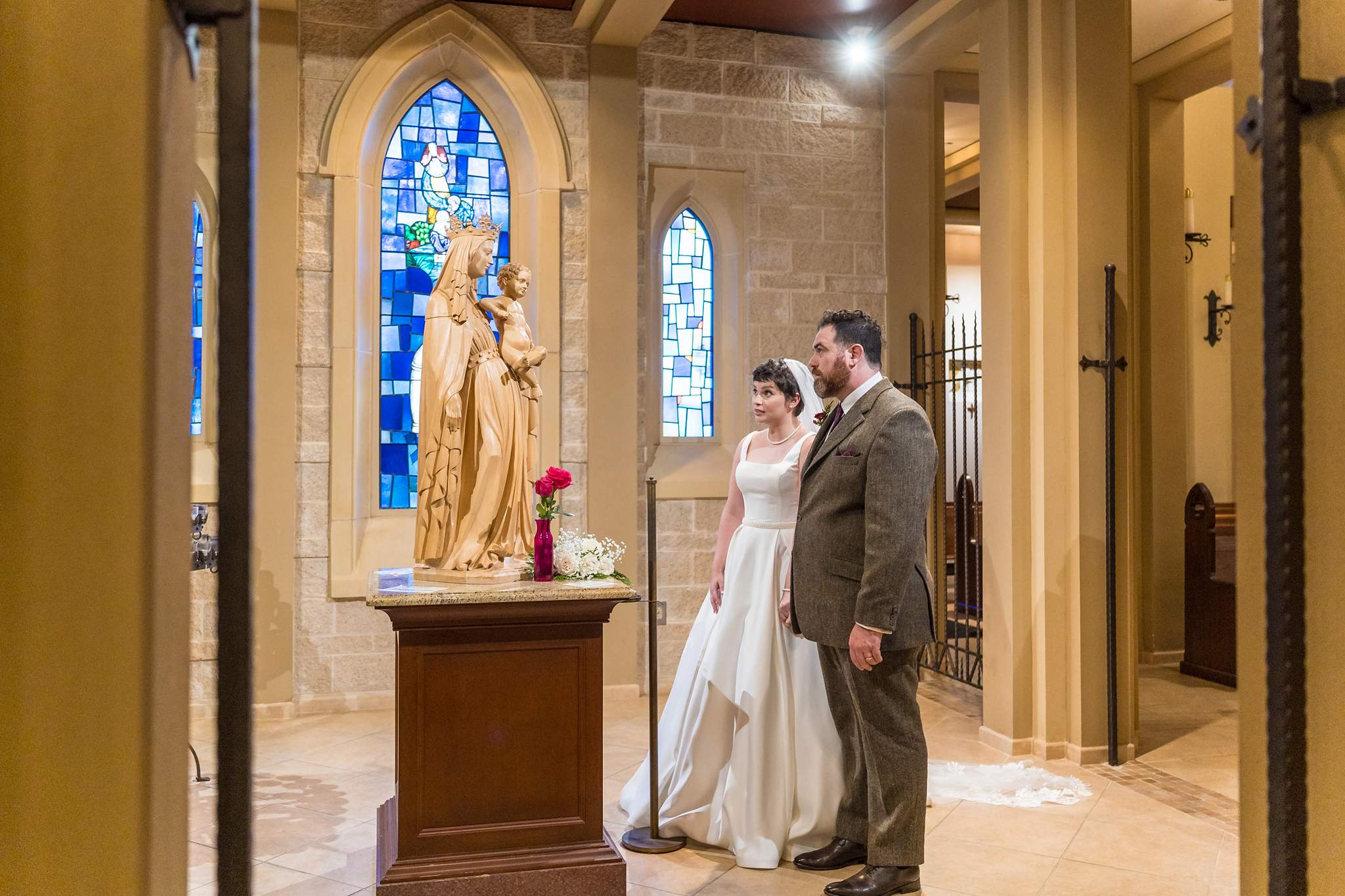 Couple at the Marian side altar inside Our Lady of the Assumption Catholic Church