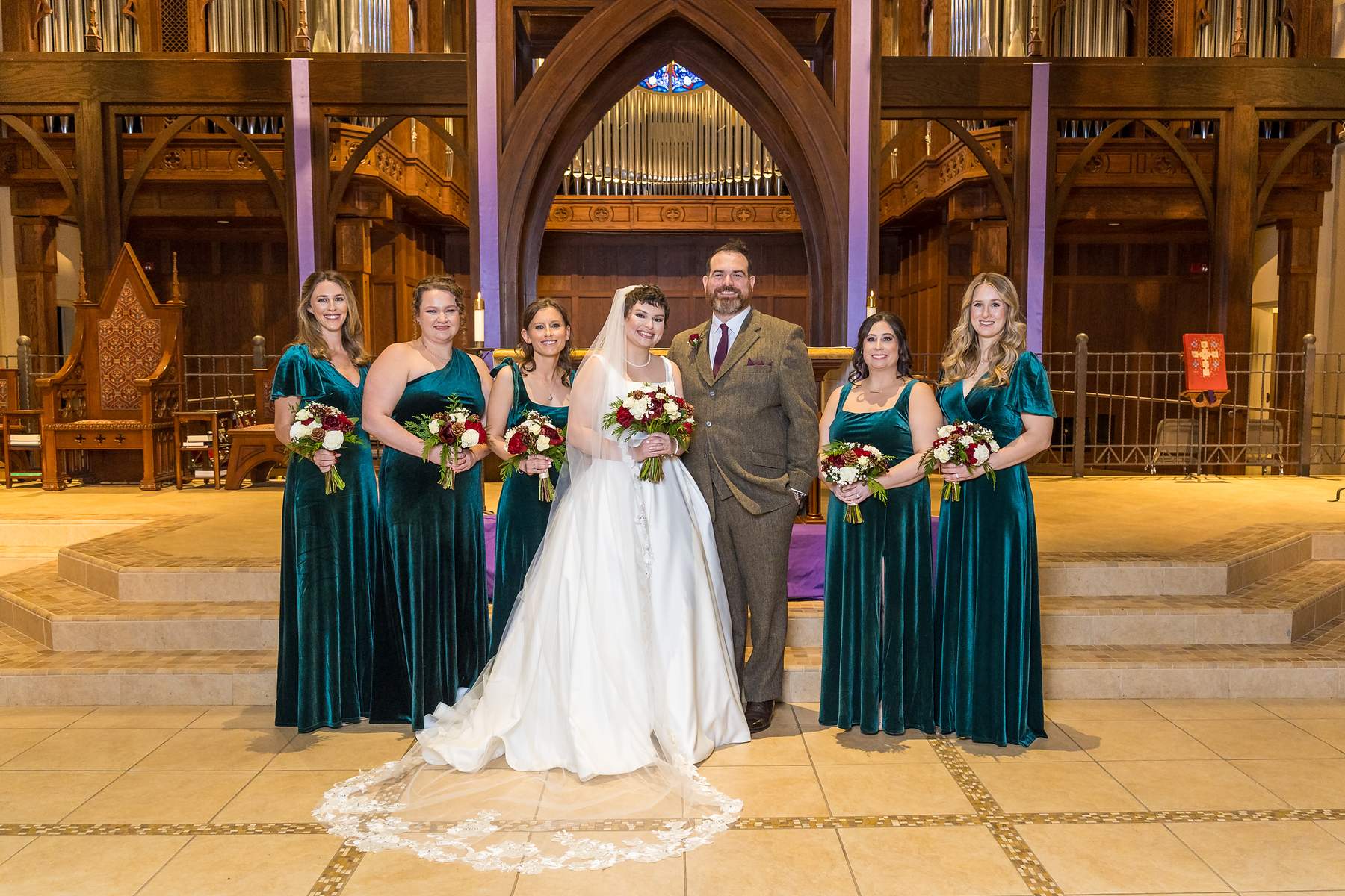 Bride and groom with bridesmaids at the altar of Our Lady of the Assumption