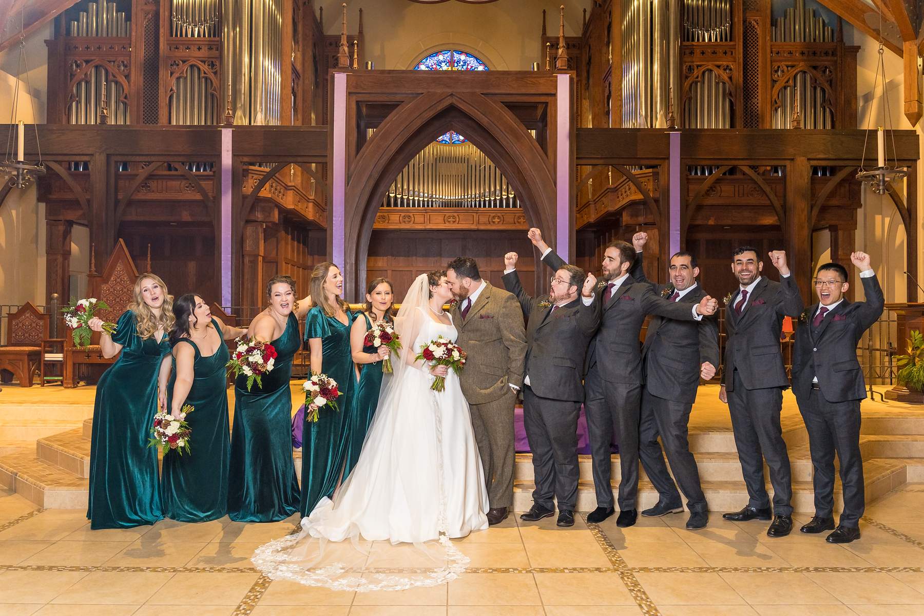 Wedding party celebrating at the altar of Our Lady of the Assumption Catholic Church