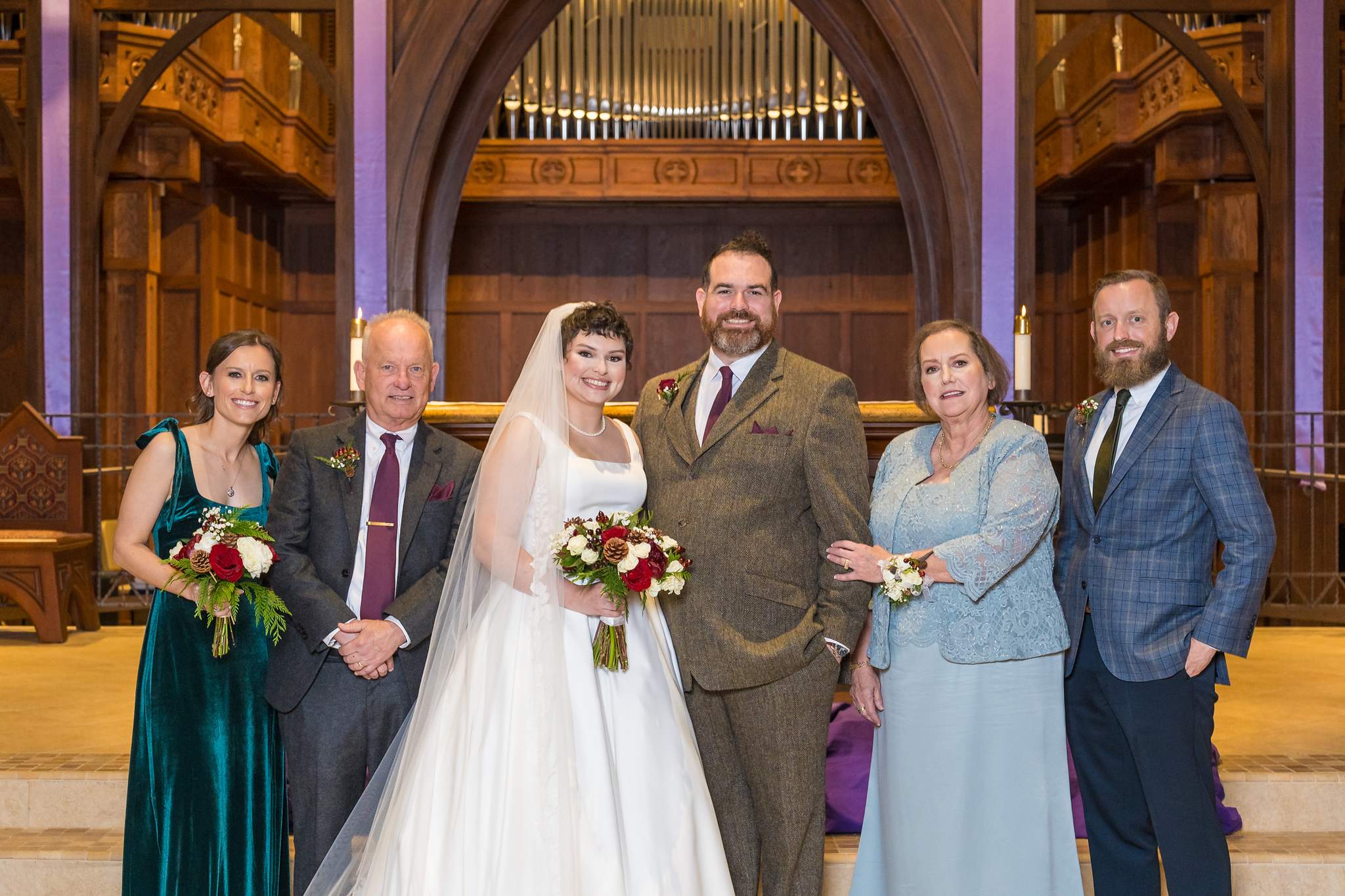 Family portrait at the altar with the pipe organ behind at Our Lady of the Assumption