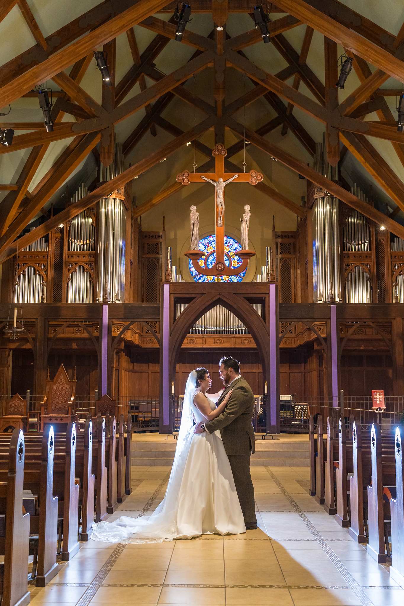 Couple portrait in the empty sanctuary of Our Lady of the Assumption Catholic Church