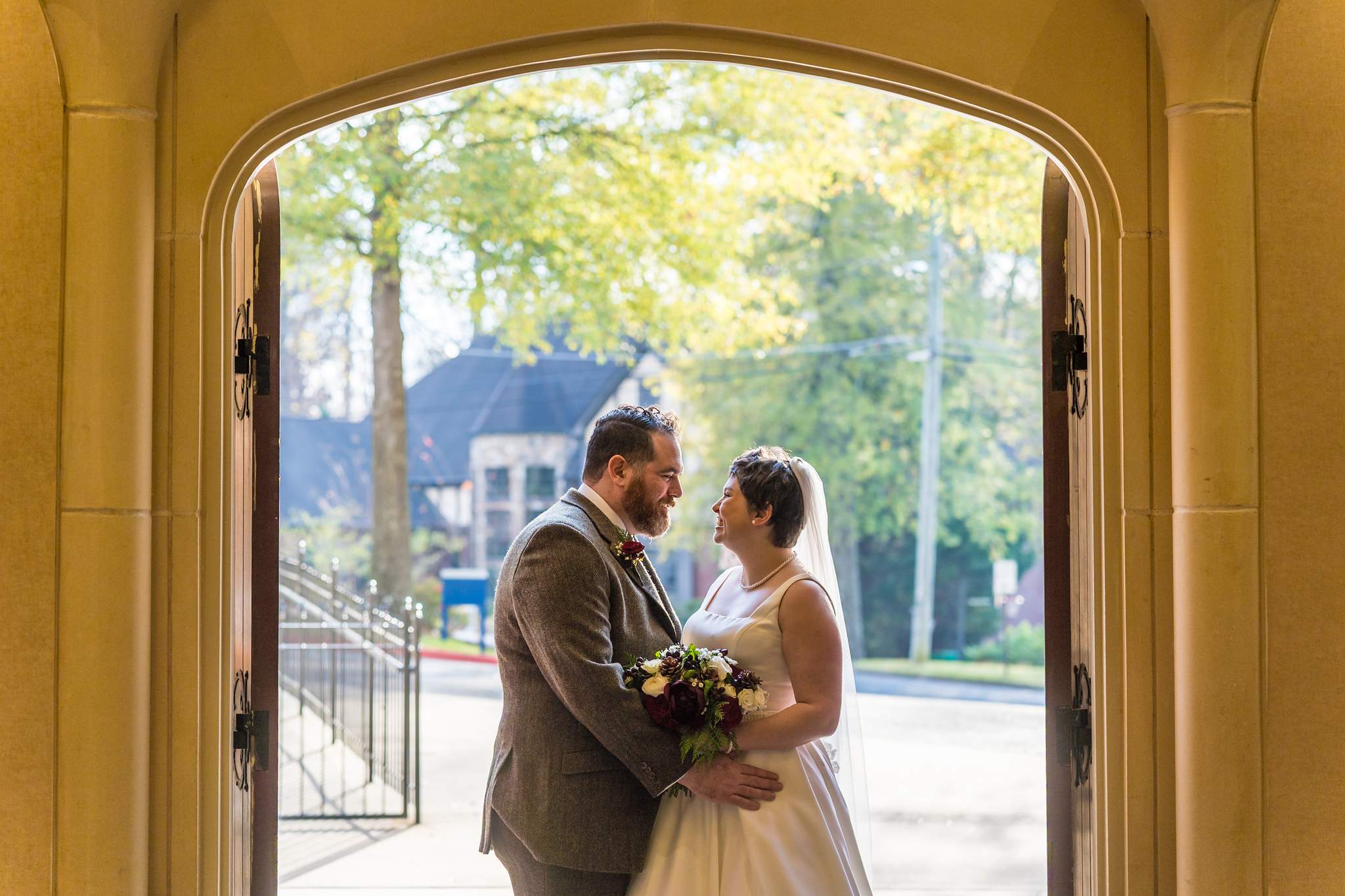 Couple portrait in the open church doors at Our Lady of the Assumption