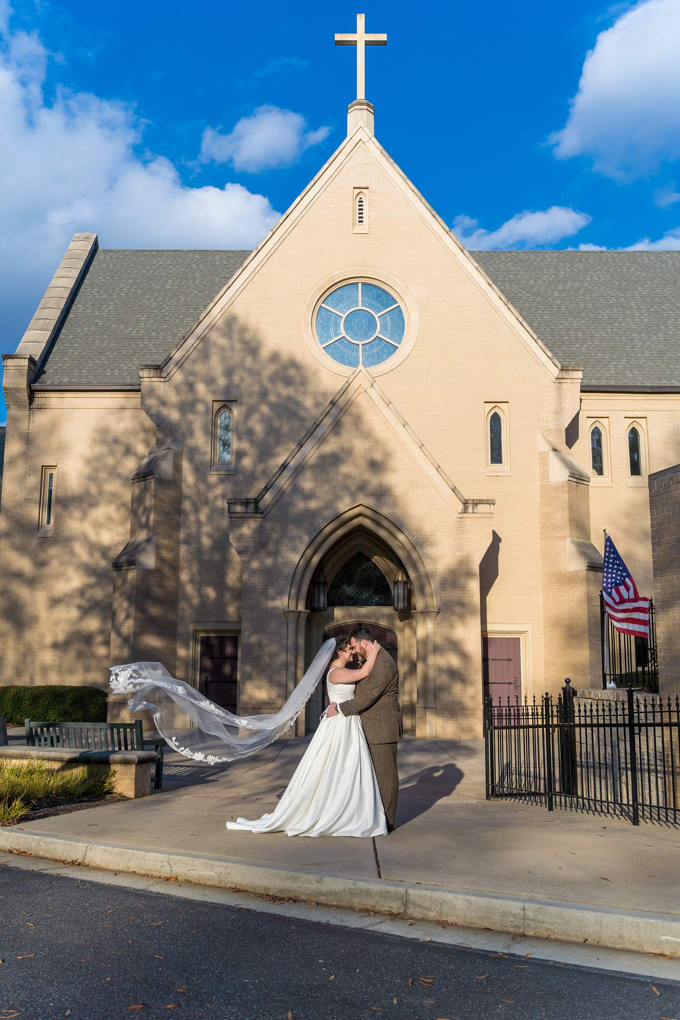Bride and groom in front of Our Lady of the Assumption Catholic Church in Brookhaven
