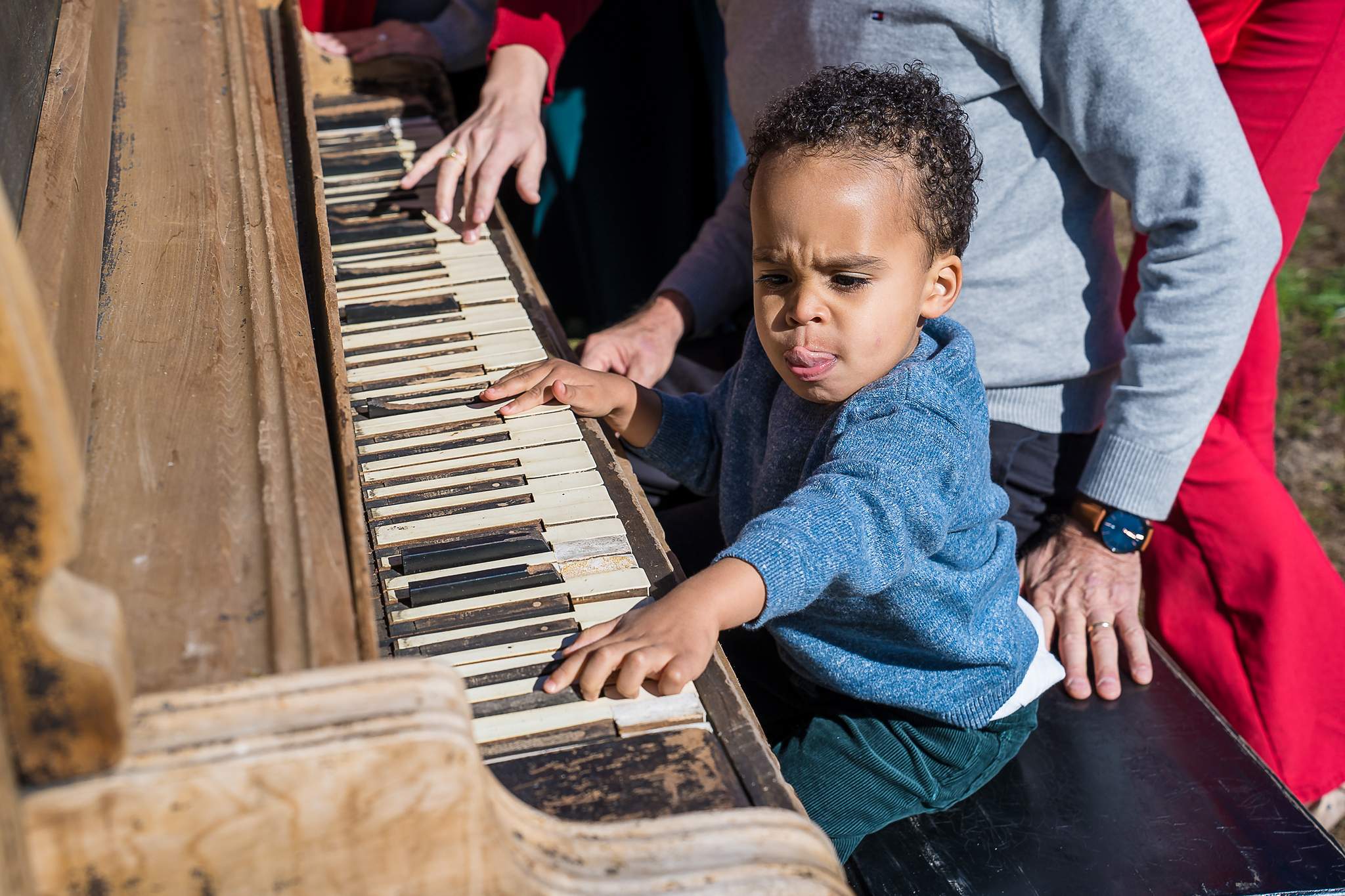 Toddler playing the keys of the vintage piano at Prospect Farms
