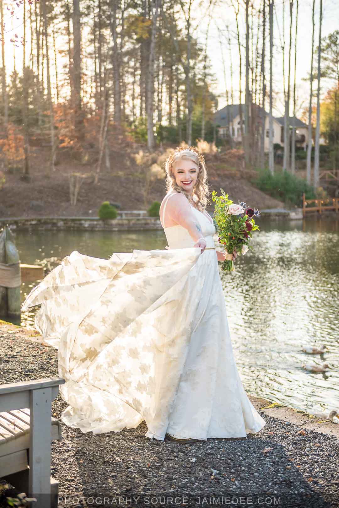 Rocky's Lake Estate Wedding Venue - Bridal Portraits - bride on her wedding day holding bouquet of flowers - full body - tossing the dress