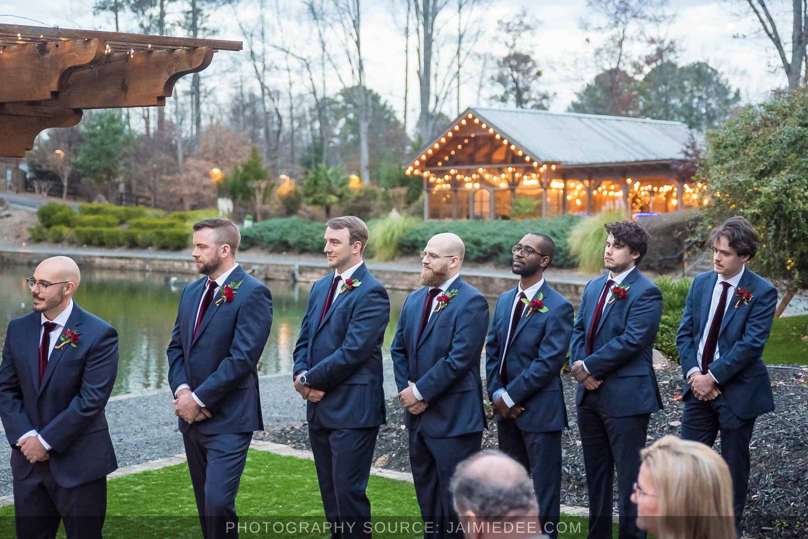 Rocky's Lake Estate Wedding Venue - Wedding ceremony - groomsmen standing and watching the ceremony