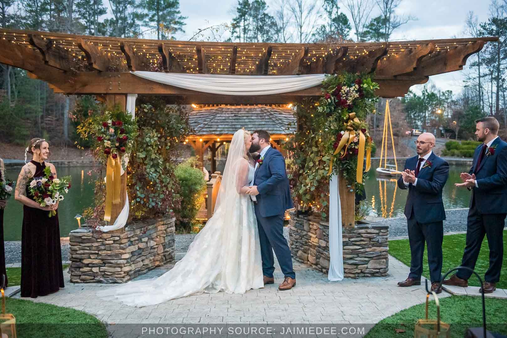 Rocky's Lake Estate Wedding Venue - Wedding ceremony - full view of ceremony site - first kiss