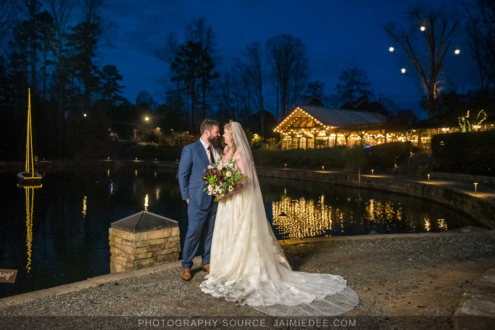 Rocky's Lake Estate Wedding Venue - bride and groom couples portrait - night time couples portraits in front of lit up venue