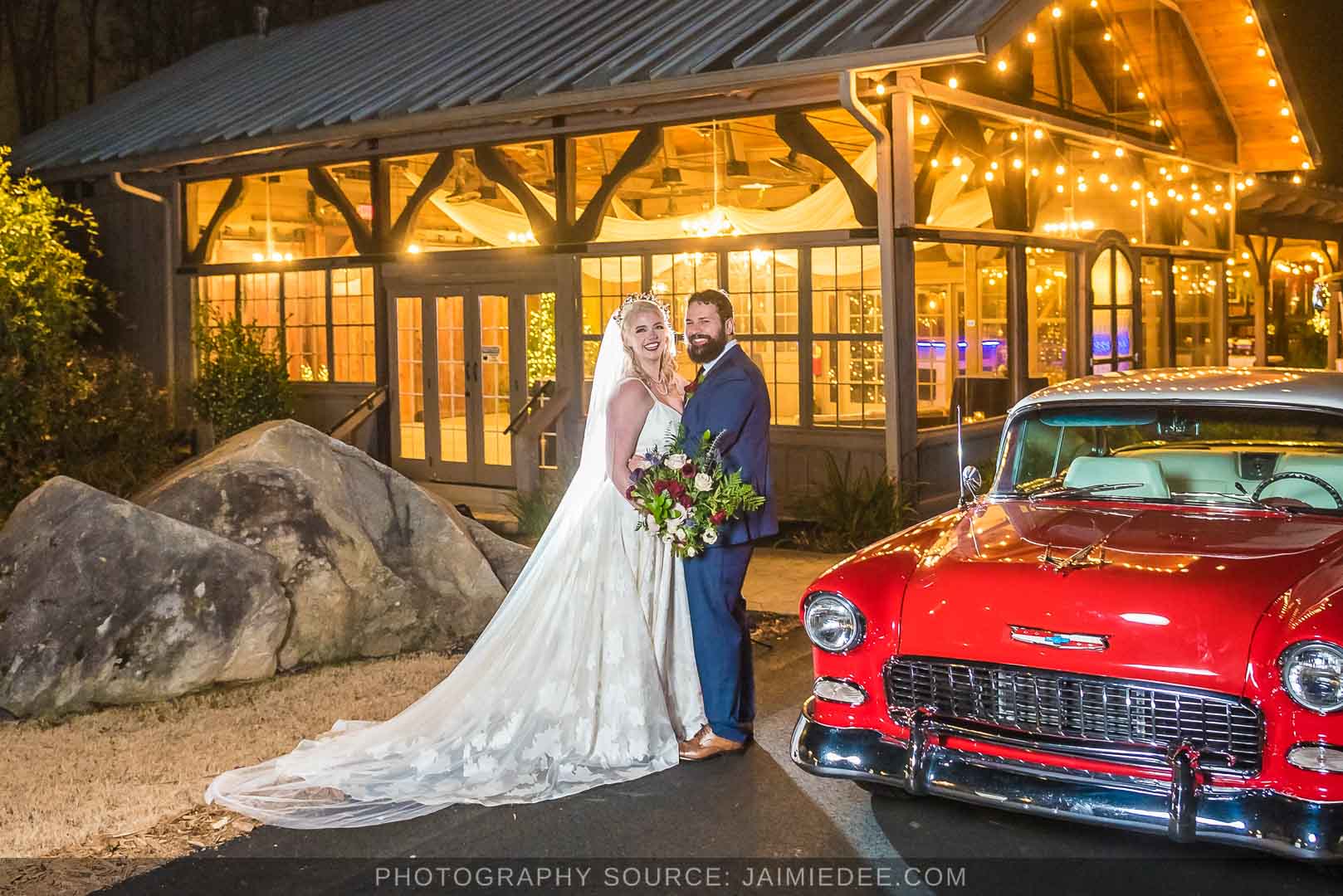 Rocky's Lake Estate Wedding Venue - bride and groom portrait - night time couples portraits in front of lit up venue with classic car
