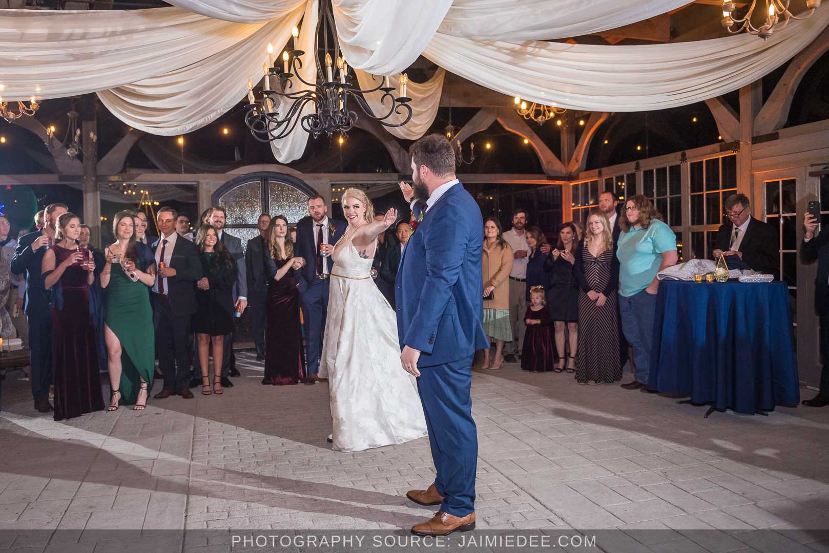 Rocky's Lake Estate Wedding Venue - reception - bride and groom's first dance together as husband and wife inside pavilion with ceiling drapes