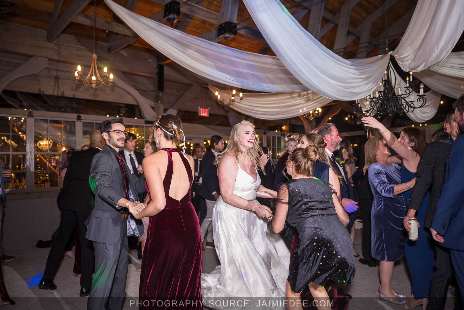 Rocky's Lake Estate Wedding Venue - reception - wedding guest dancing inside pavilion with ceiling drapes