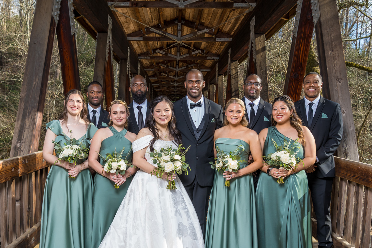 Flash photography on mixed skin tones on covered bridge at park near Roswell Mill Club wedding