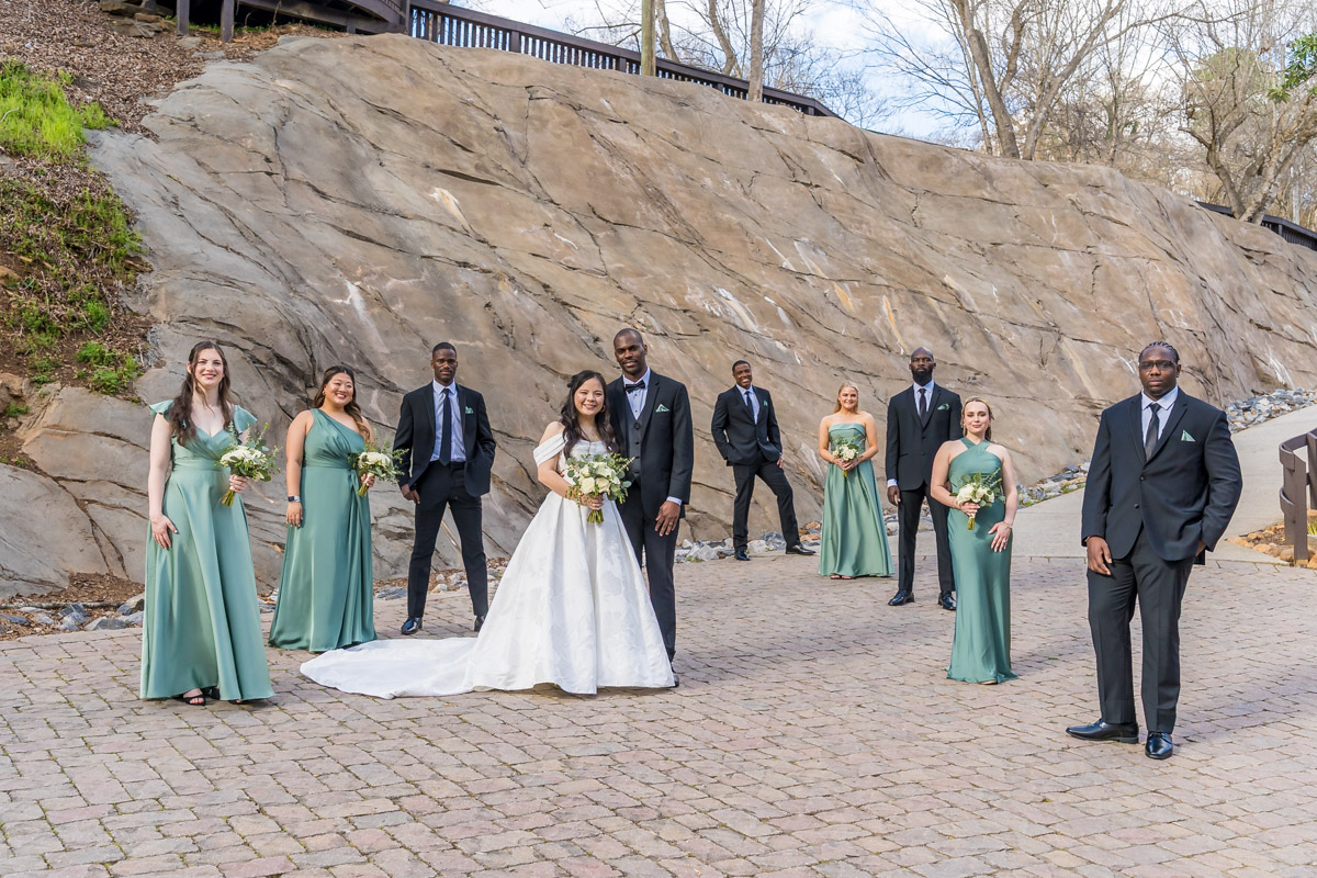 Interracial bridal party/ wedding party at park near Roswell Mill Club wedding venue