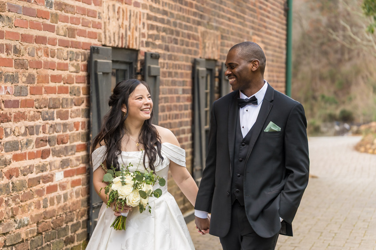 Close up of bride and groom by brick wall in downtown Roswell park for Roswell Mill Club wedding photos