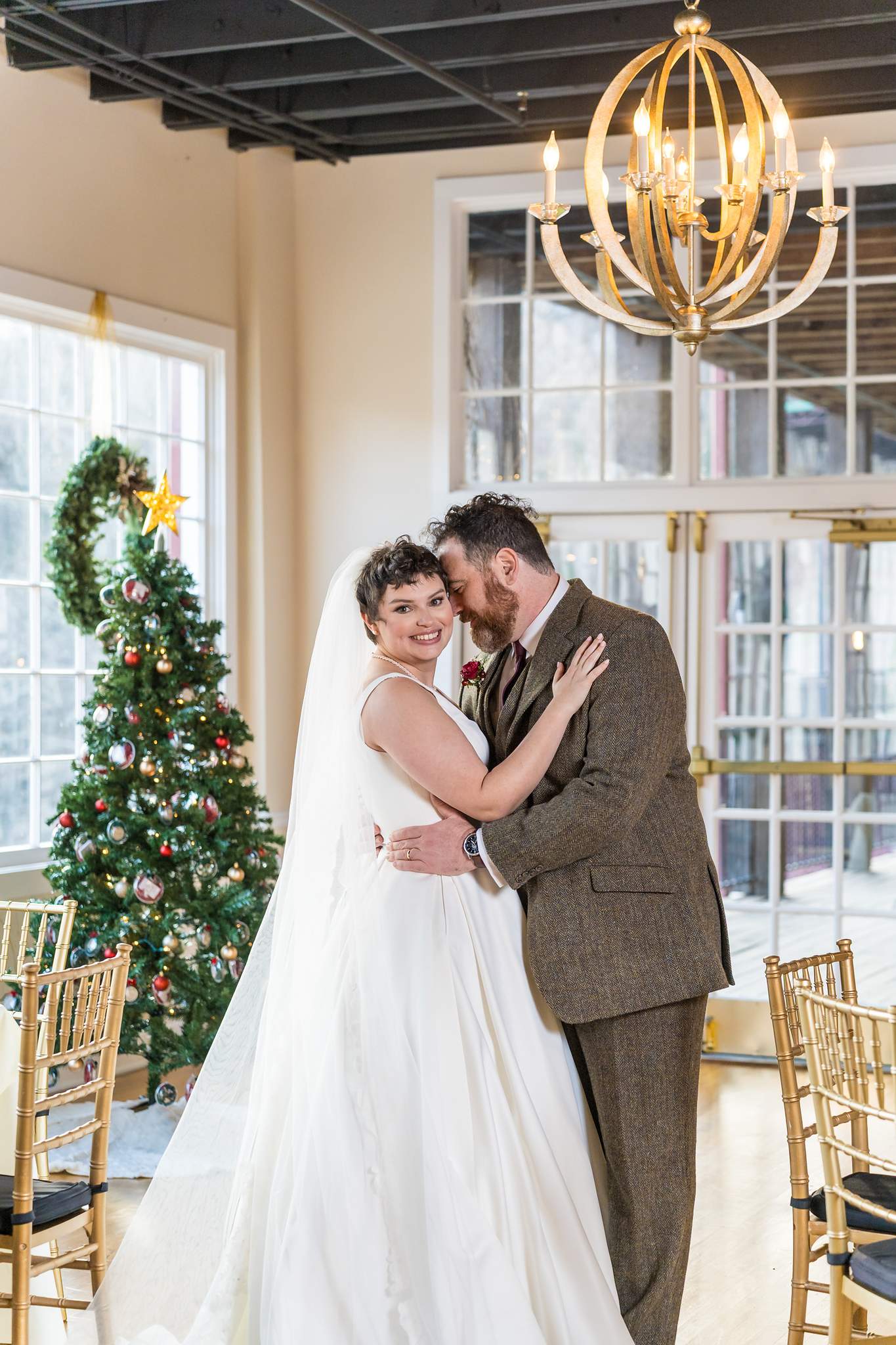 Couple portrait beside a Christmas tree at Roswell Mill Club