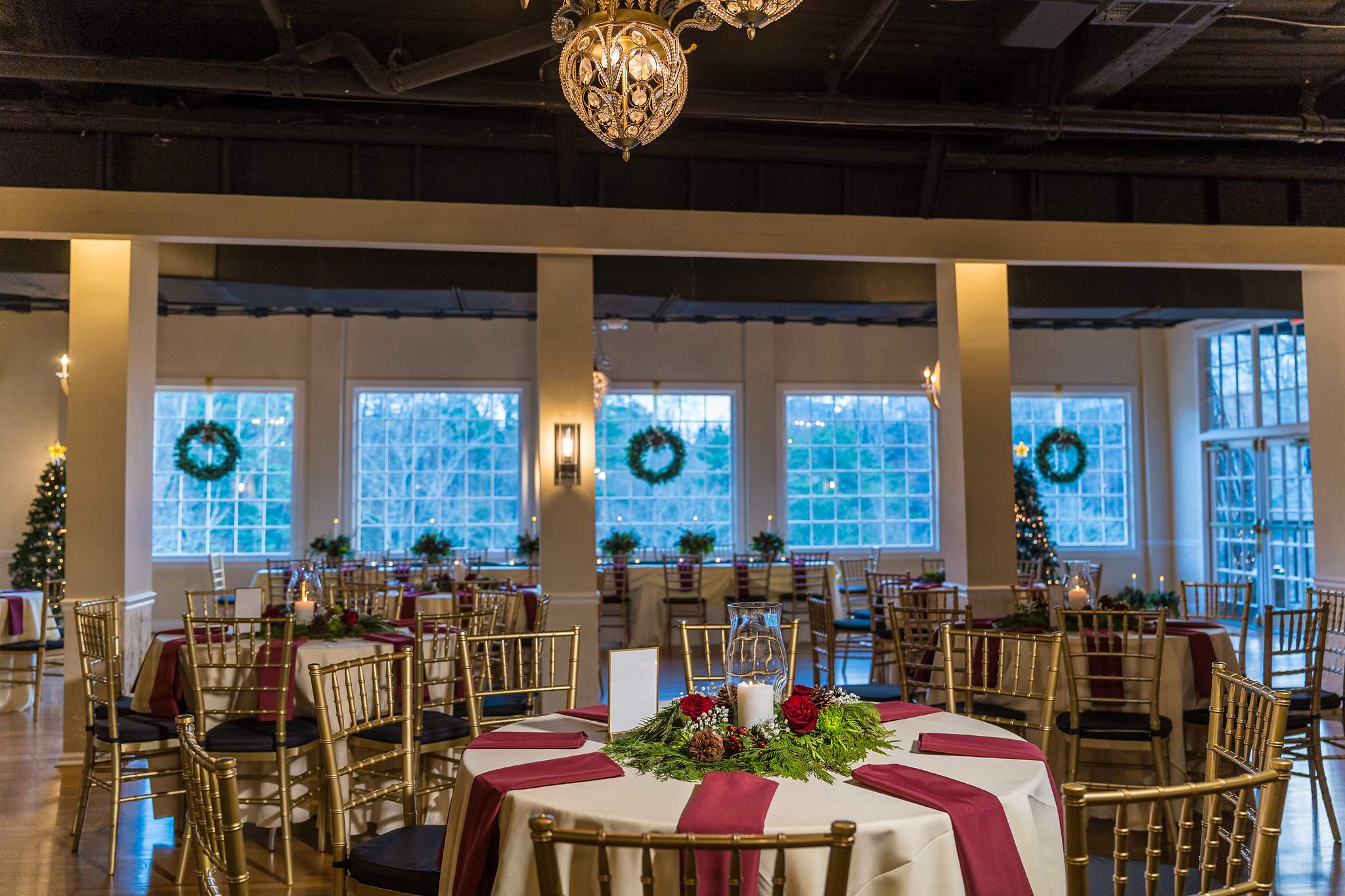Reception room set with wreaths and holiday centerpieces at Roswell Mill Club