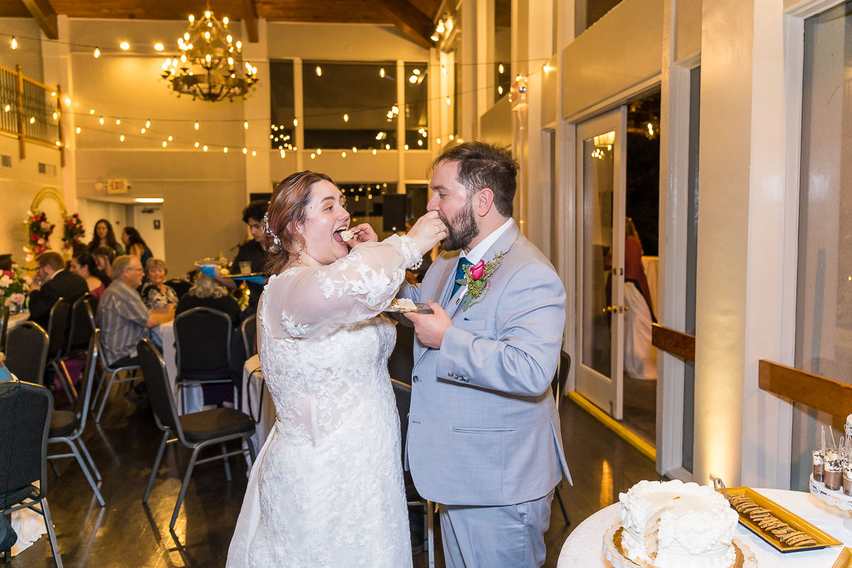 Roswell River Landing Wedding Photos of Cake Cutting Featuring Reception Room Interior