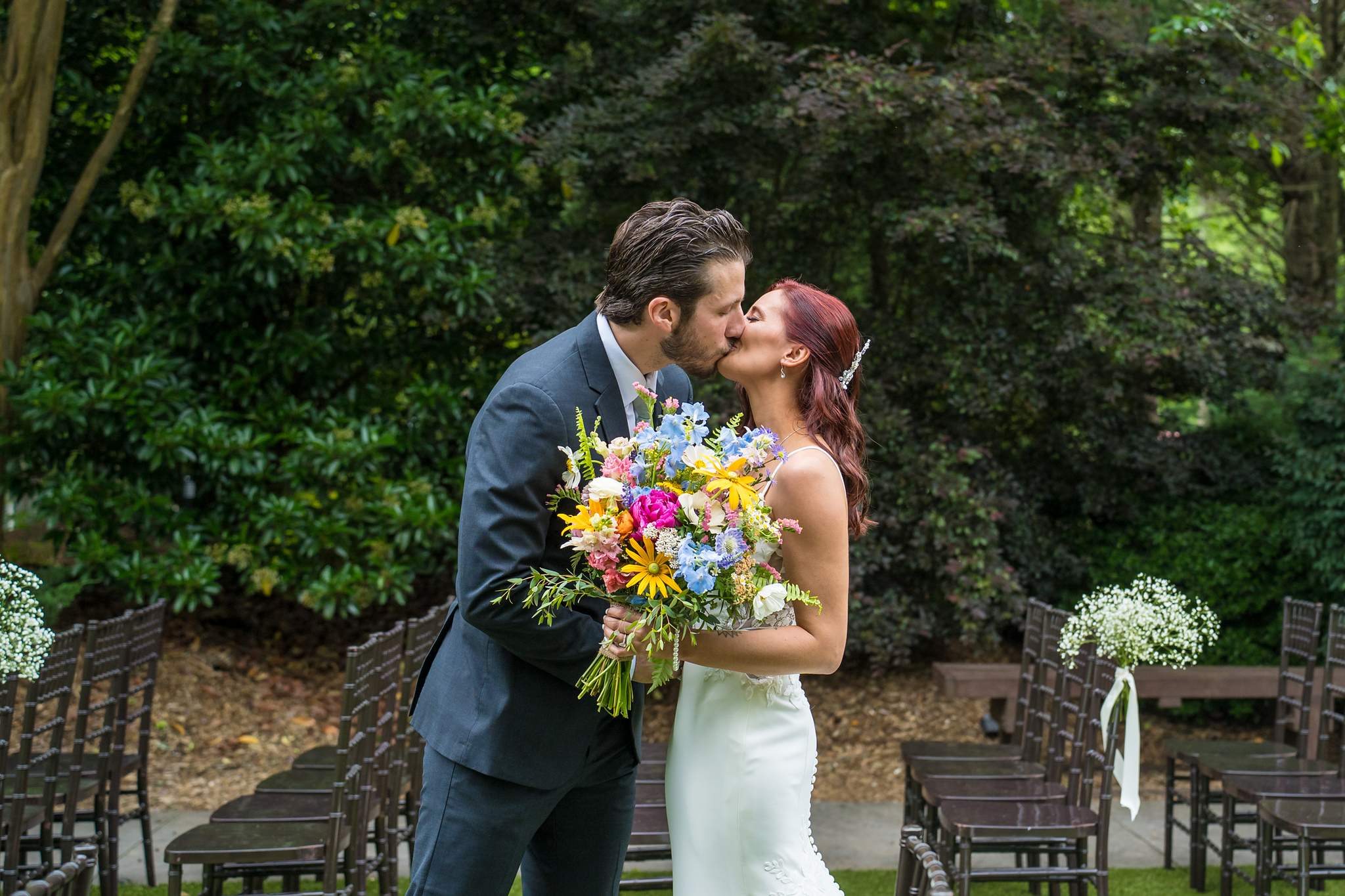 Couple kissing after their first look on the ceremony lawn at Shiloh Gardens