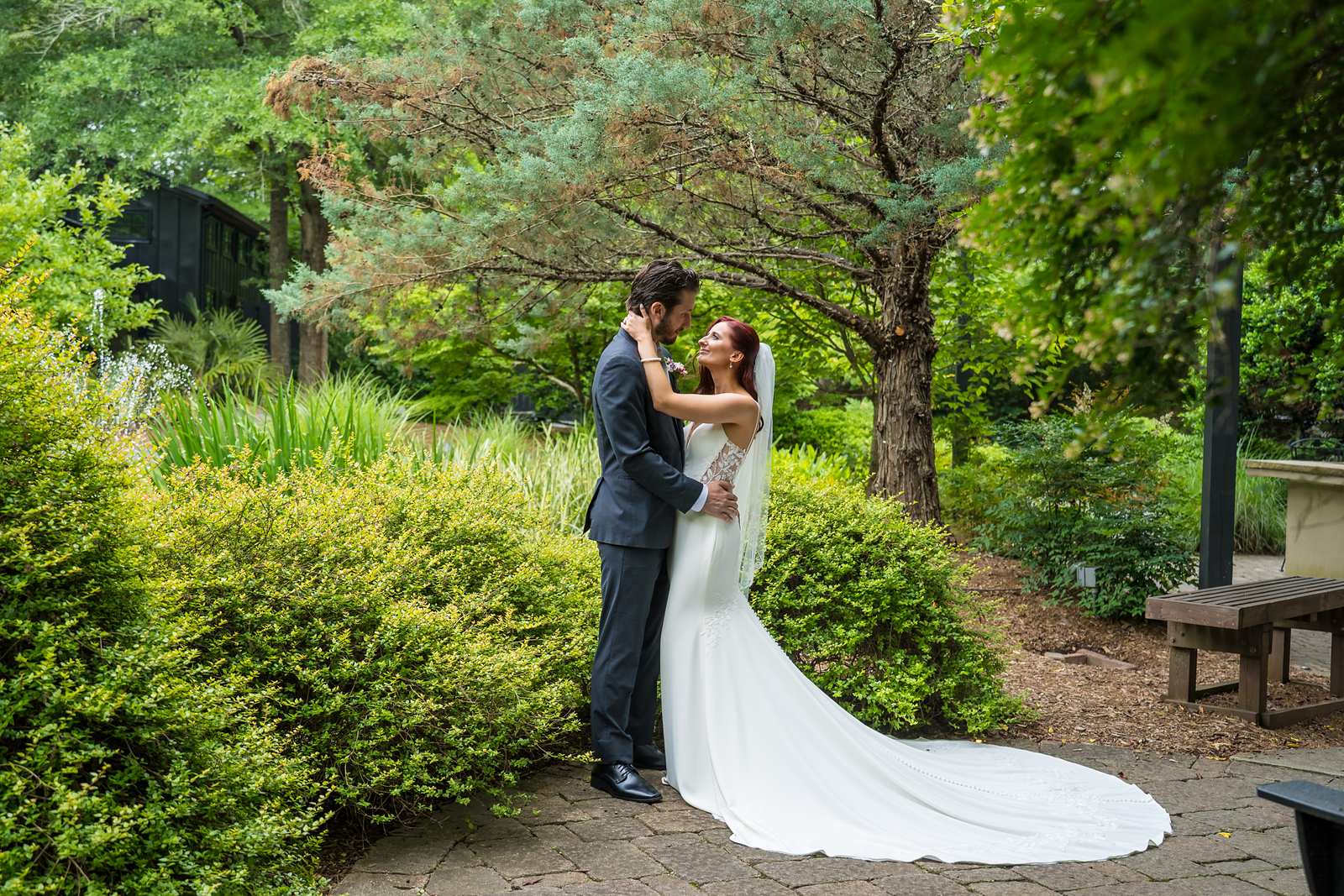 Couple embracing on a garden path at Shiloh Gardens Special Events Venue