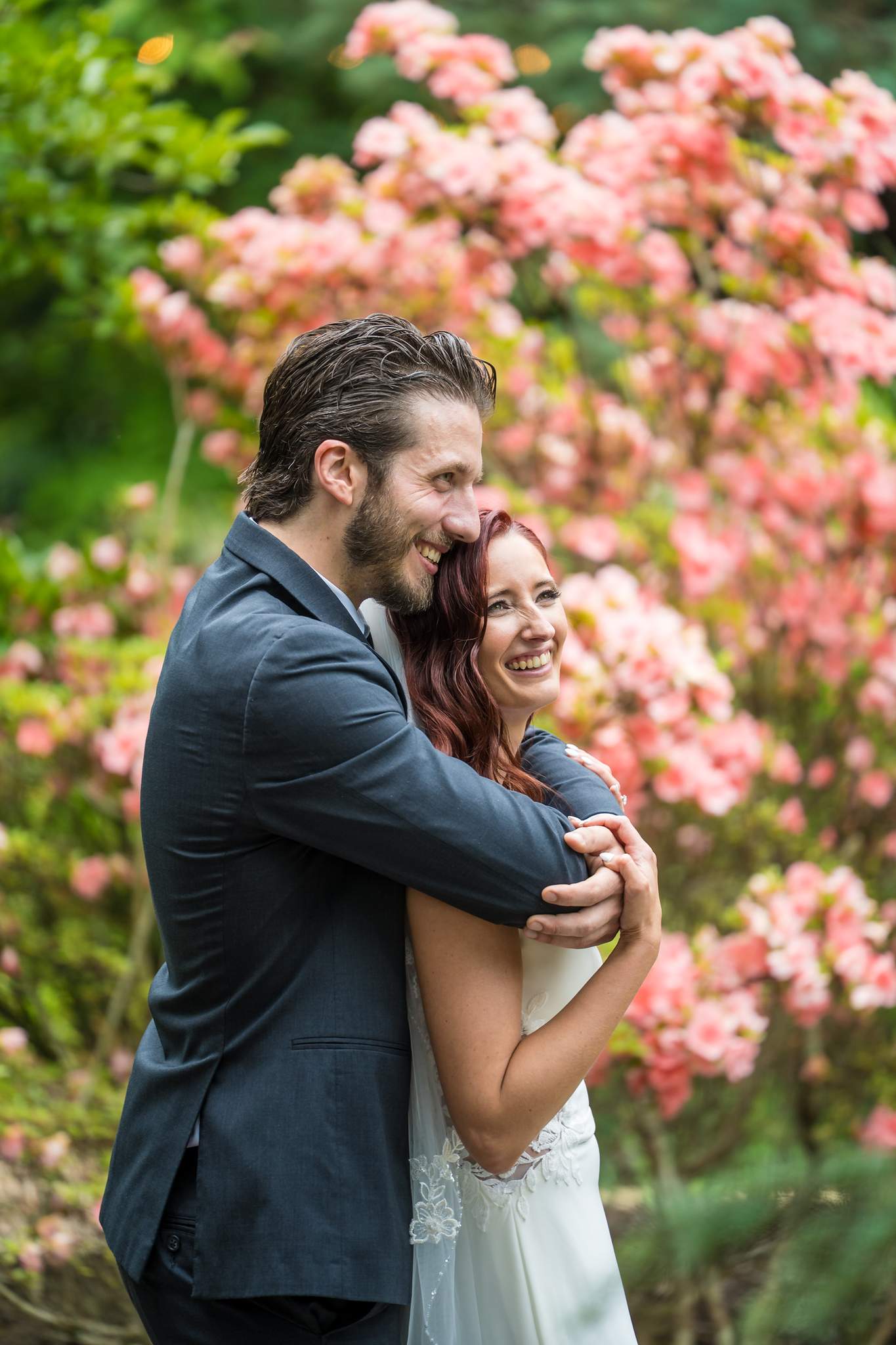 Couple portrait with pink azaleas in the gardens at Shiloh Gardens