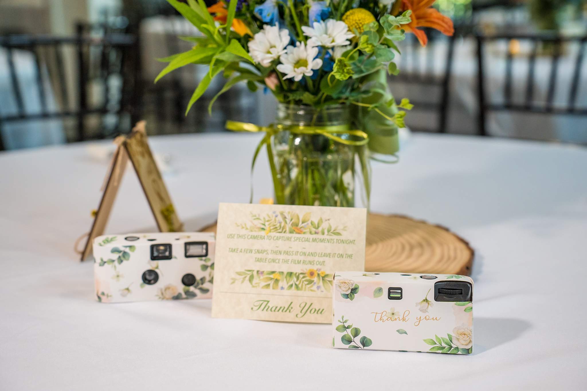 Reception table details with a wildflower centerpiece at Shiloh Gardens