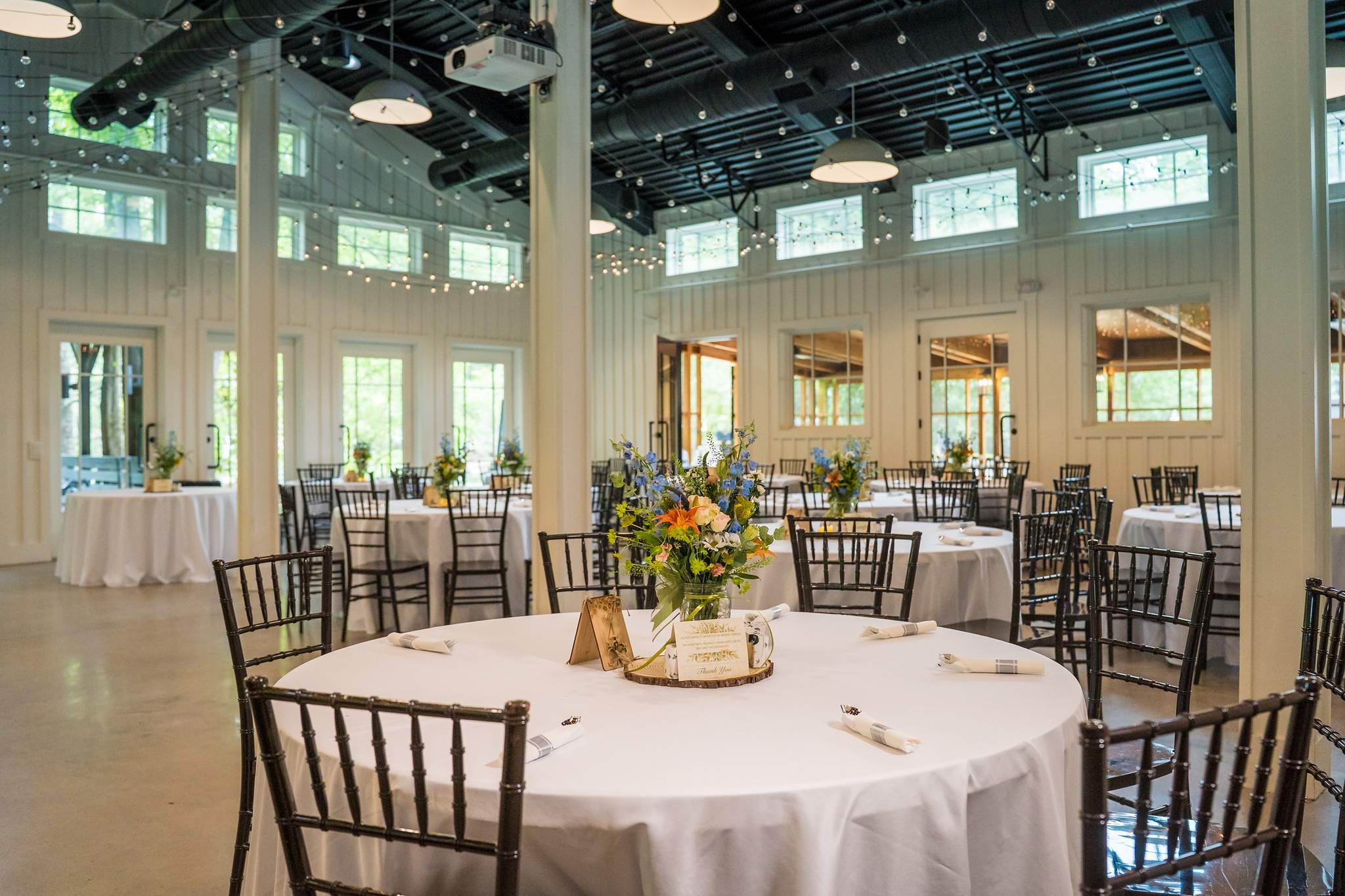 Giaquinto Event Center set for a wedding reception with large windows at Shiloh Gardens