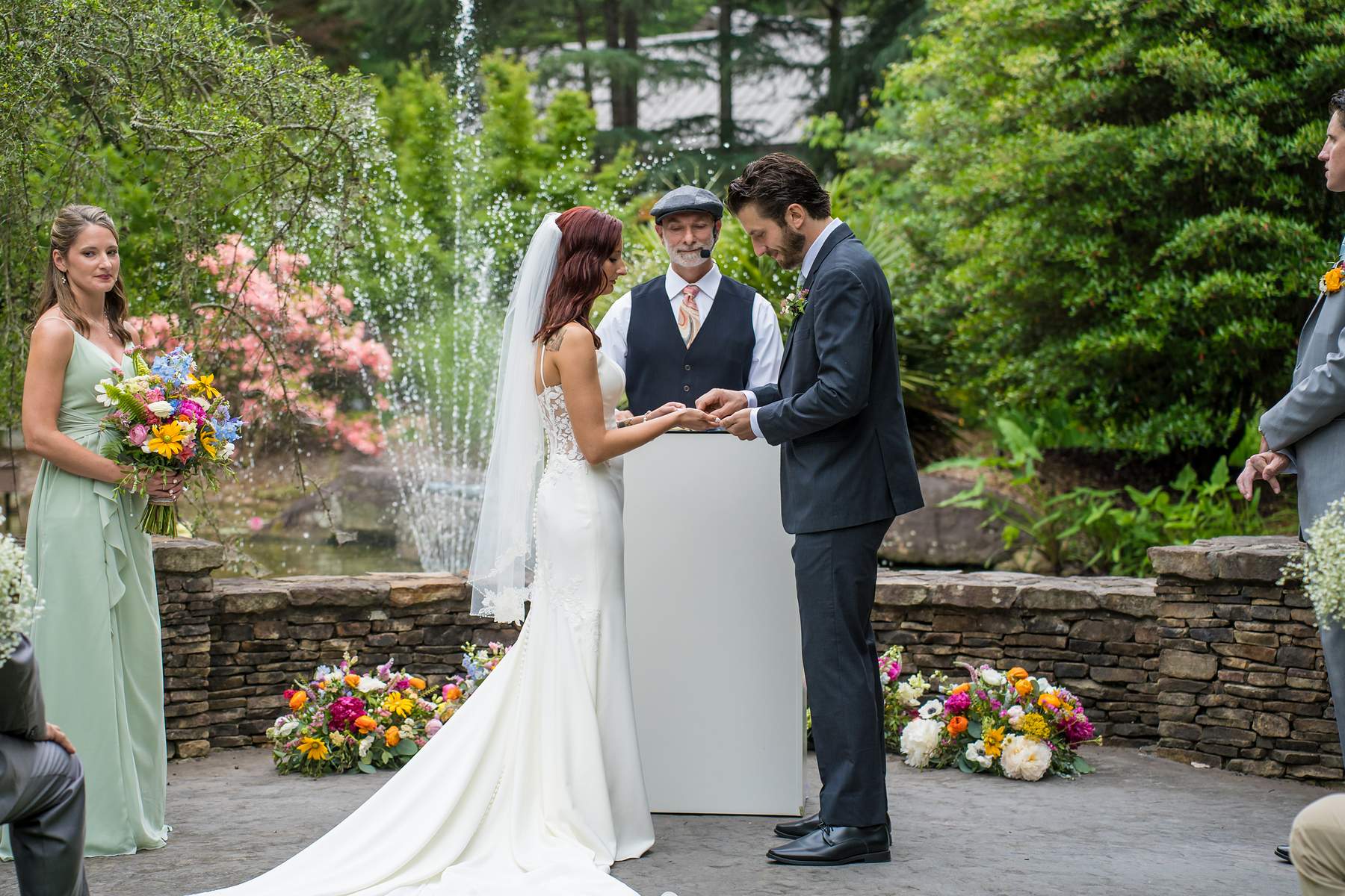 Couple exchanging vows beside the fountains at Shiloh Gardens
