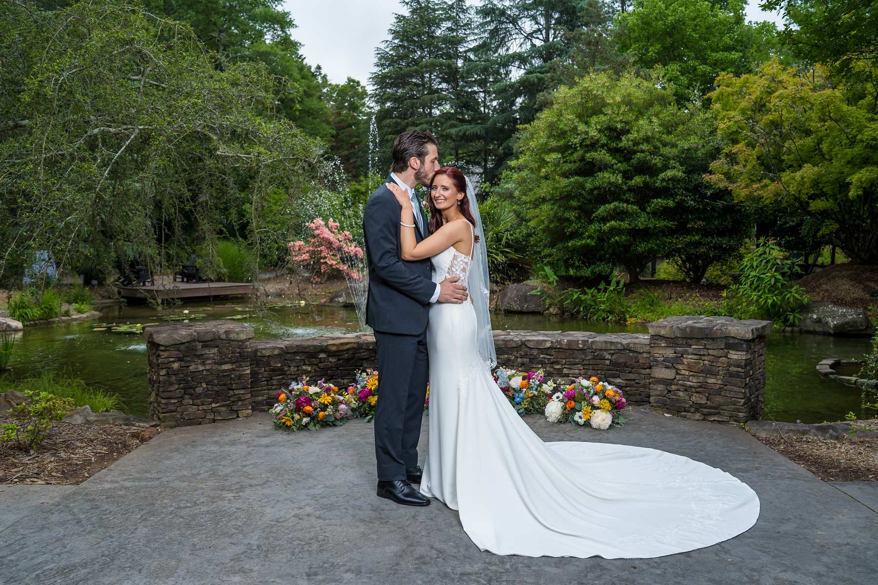 Couple portrait in the courtyard by the pond at Shiloh Gardens