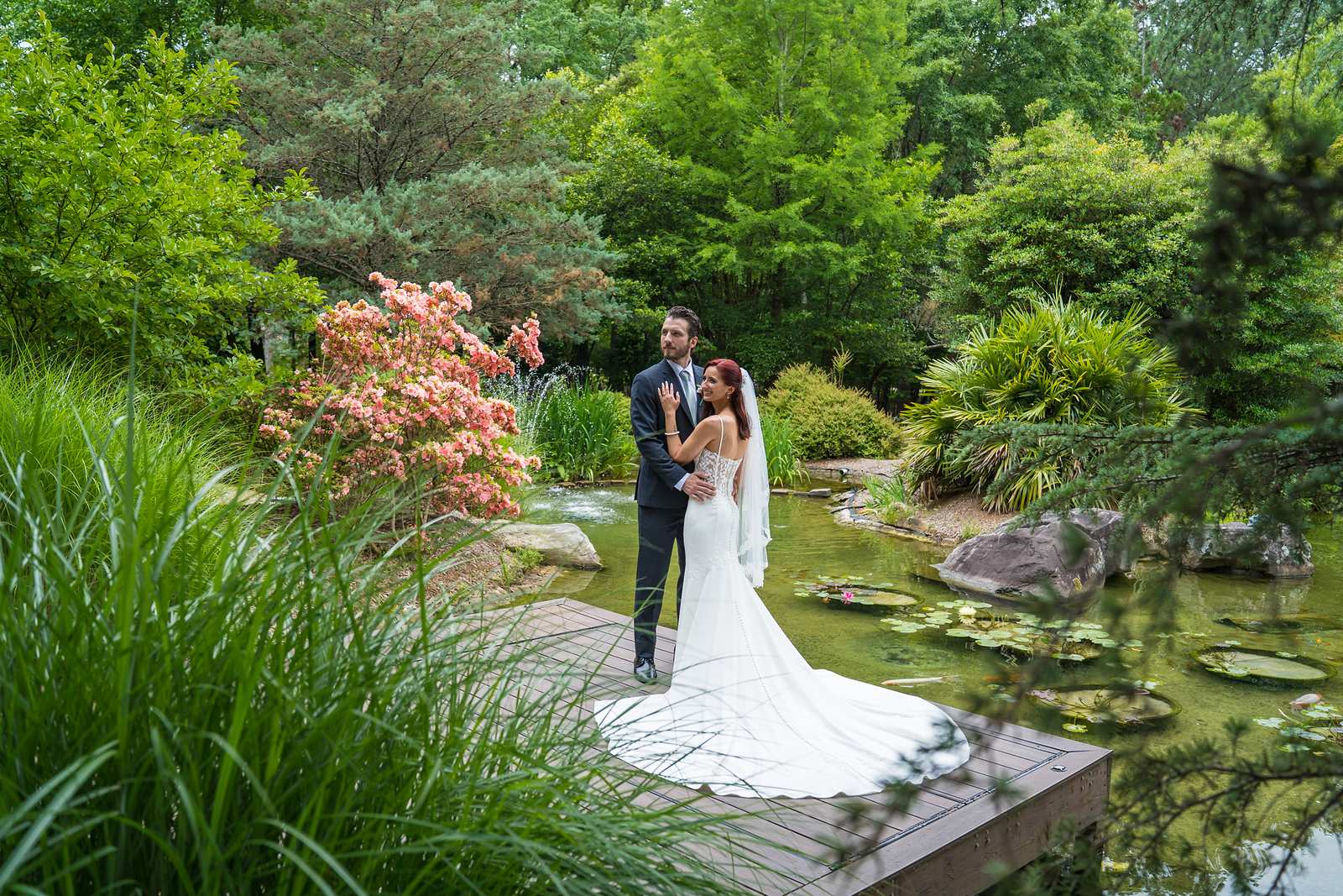 Couple on the dock surrounded by gardens and the lake at Shiloh Gardens