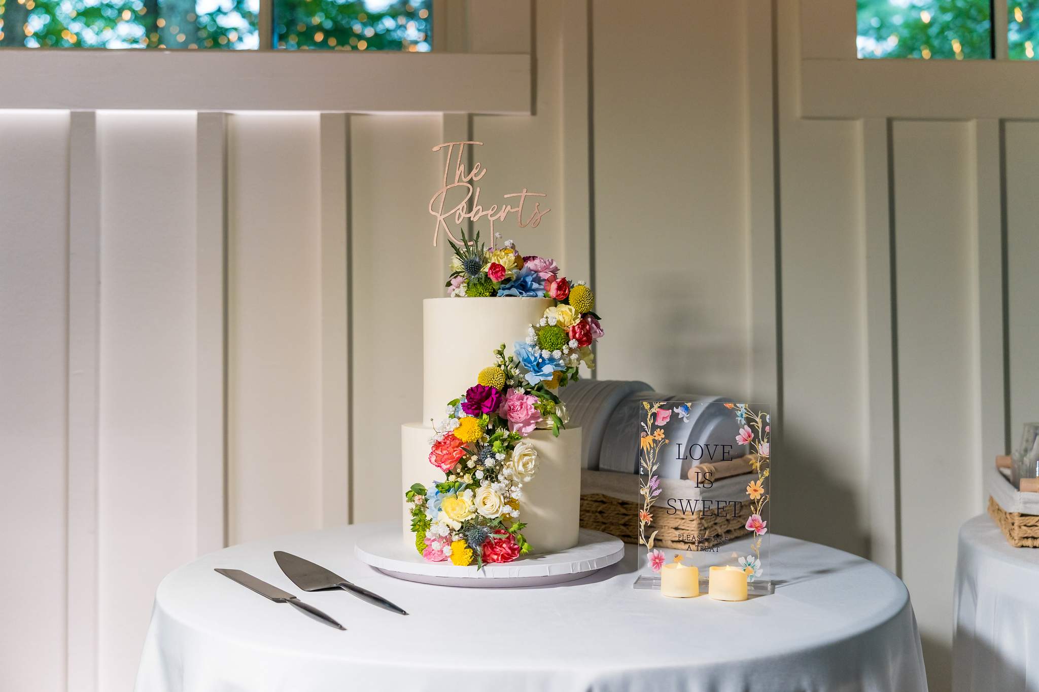 Wedding cake with colorful flowers at a Shiloh Gardens reception