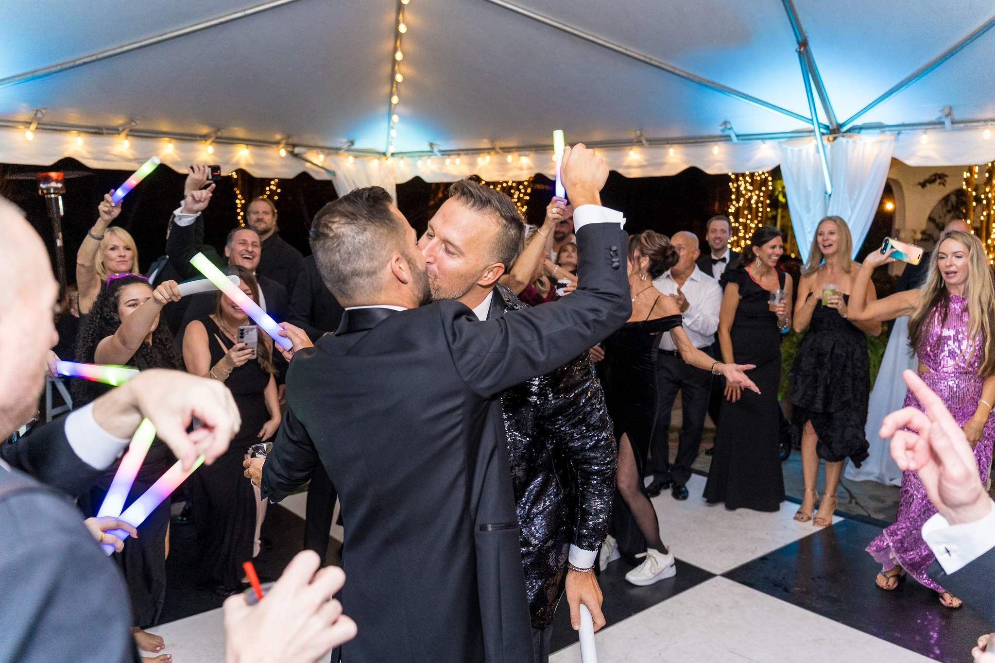 Guests dancing with glow sticks under the reception tent at The Cedars in Acworth