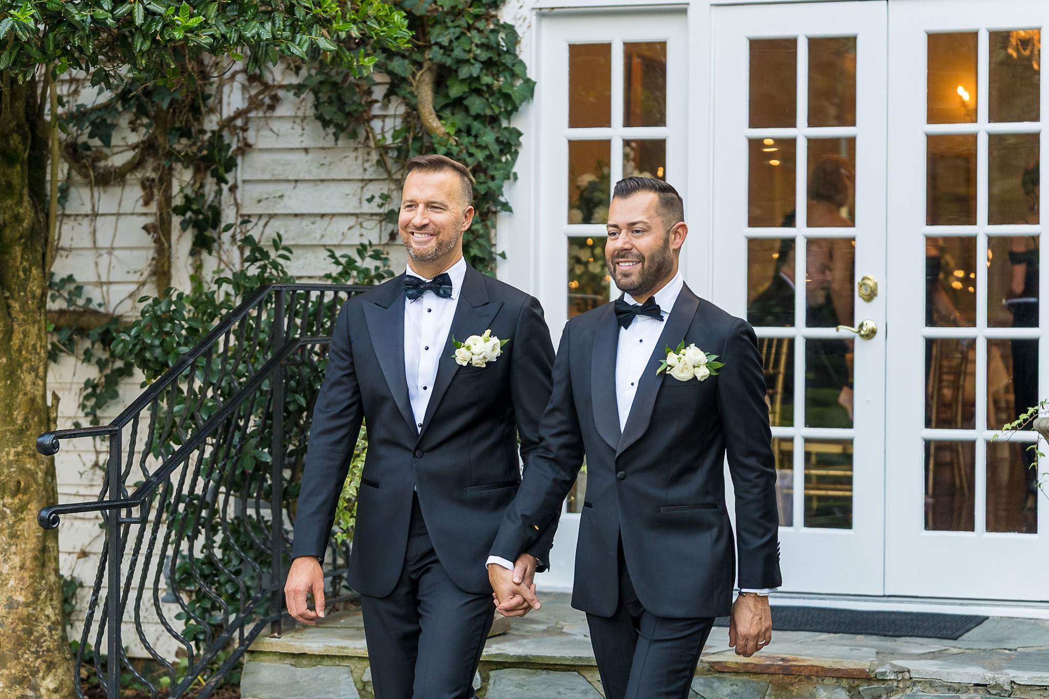 Couple in tuxedos by the French doors at The Cedars in Acworth