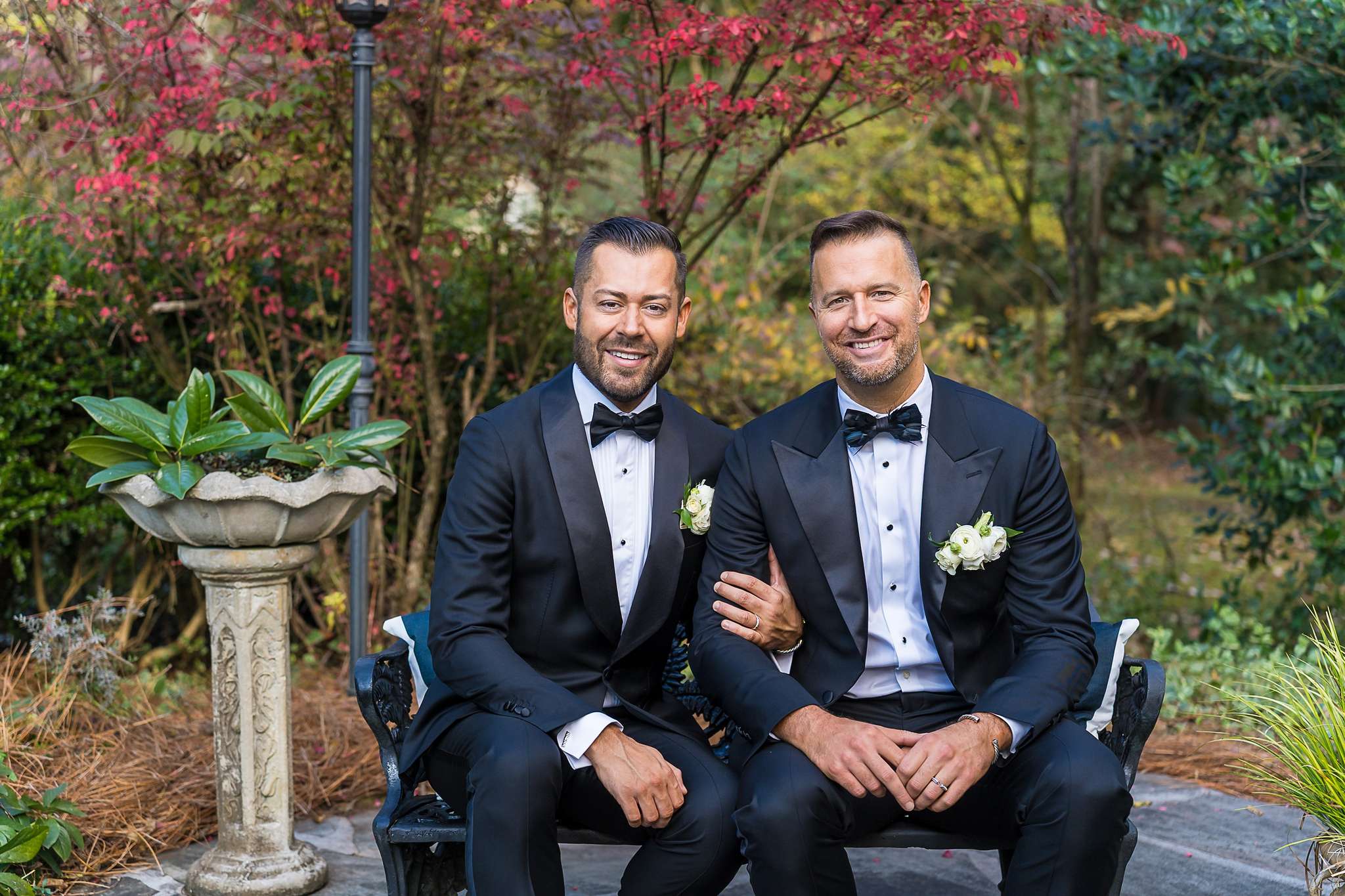 Couple seated in the garden among fall color at The Cedars in Acworth