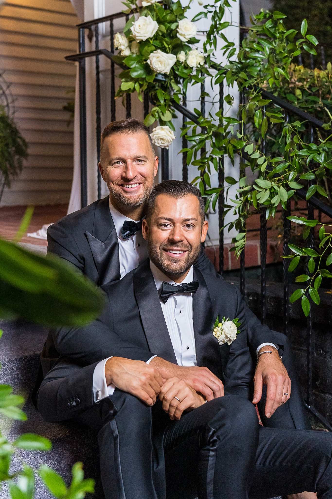 Relaxed couple portrait by the iron railing at The Cedars in Acworth