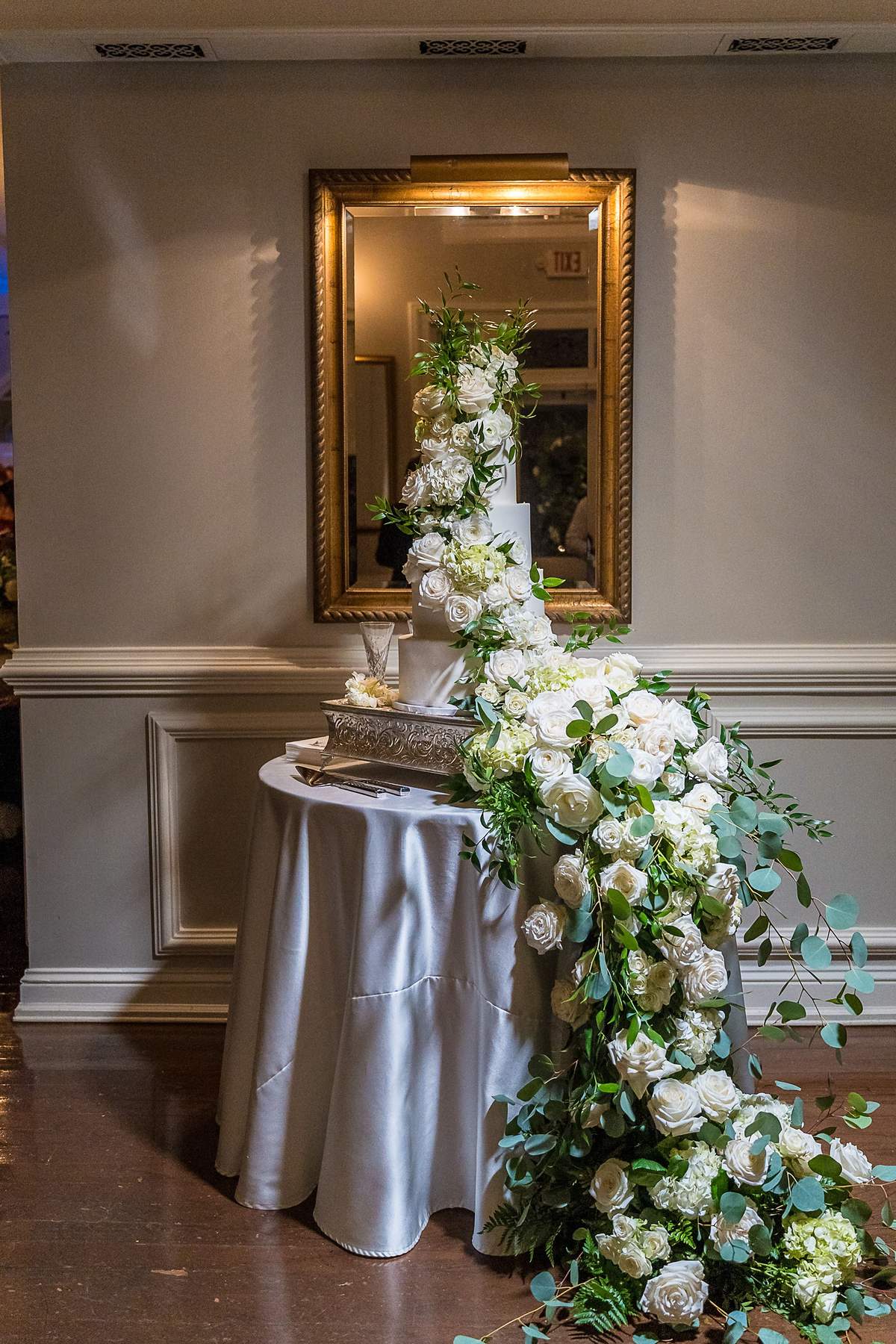 Wedding cake with cascading white flowers at The Cedars in Acworth