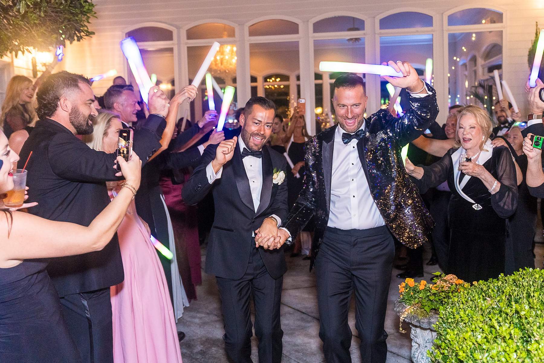 Couple making a glow stick entrance into their reception at The Cedars in Acworth