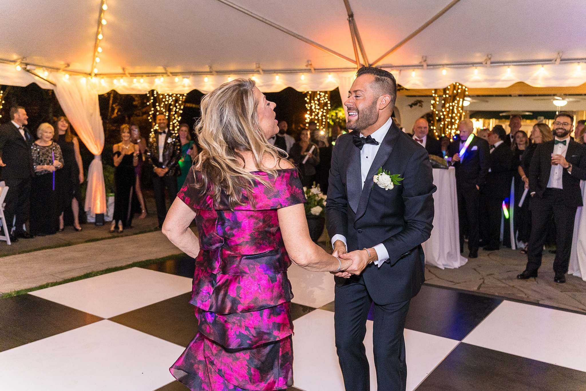 Groom dancing with a family member under the tent at The Cedars in Acworth