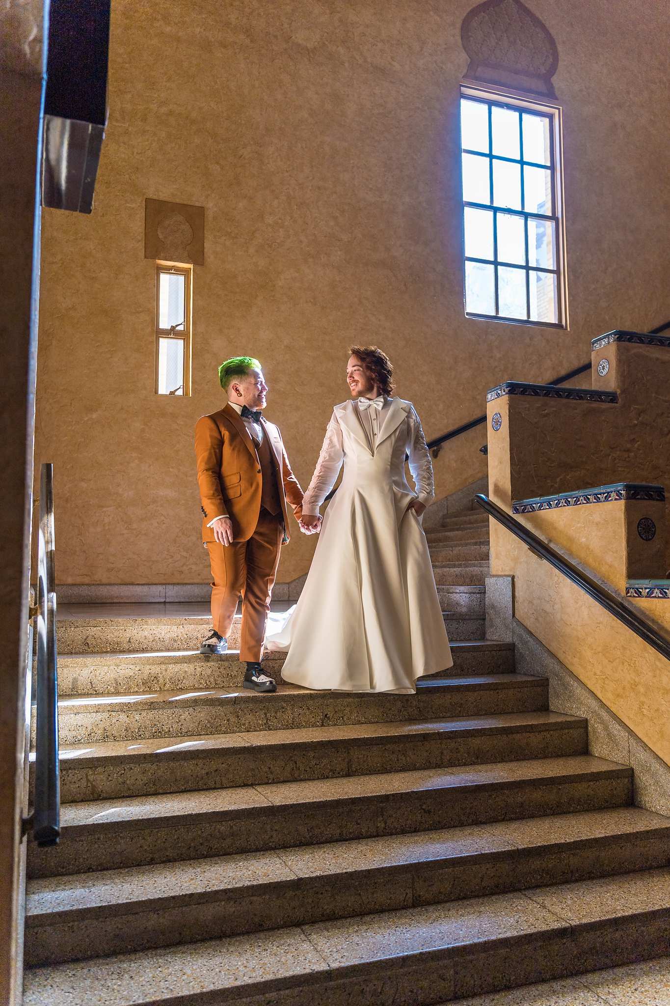 Couple walking down the Fox Theatre staircase on their wedding day