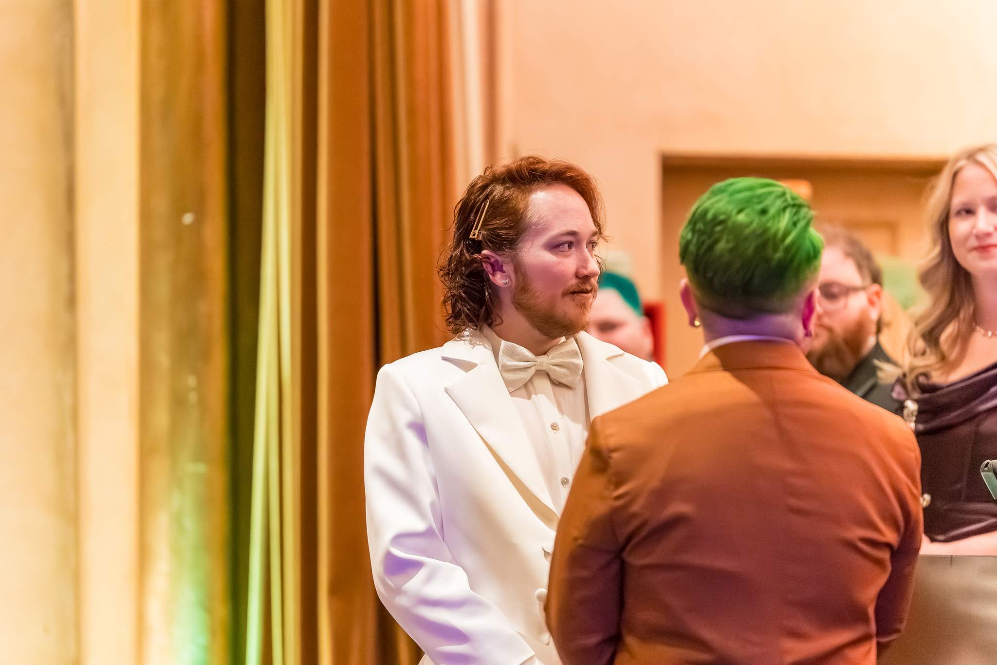Couple facing each other during their Egyptian Ballroom wedding ceremony