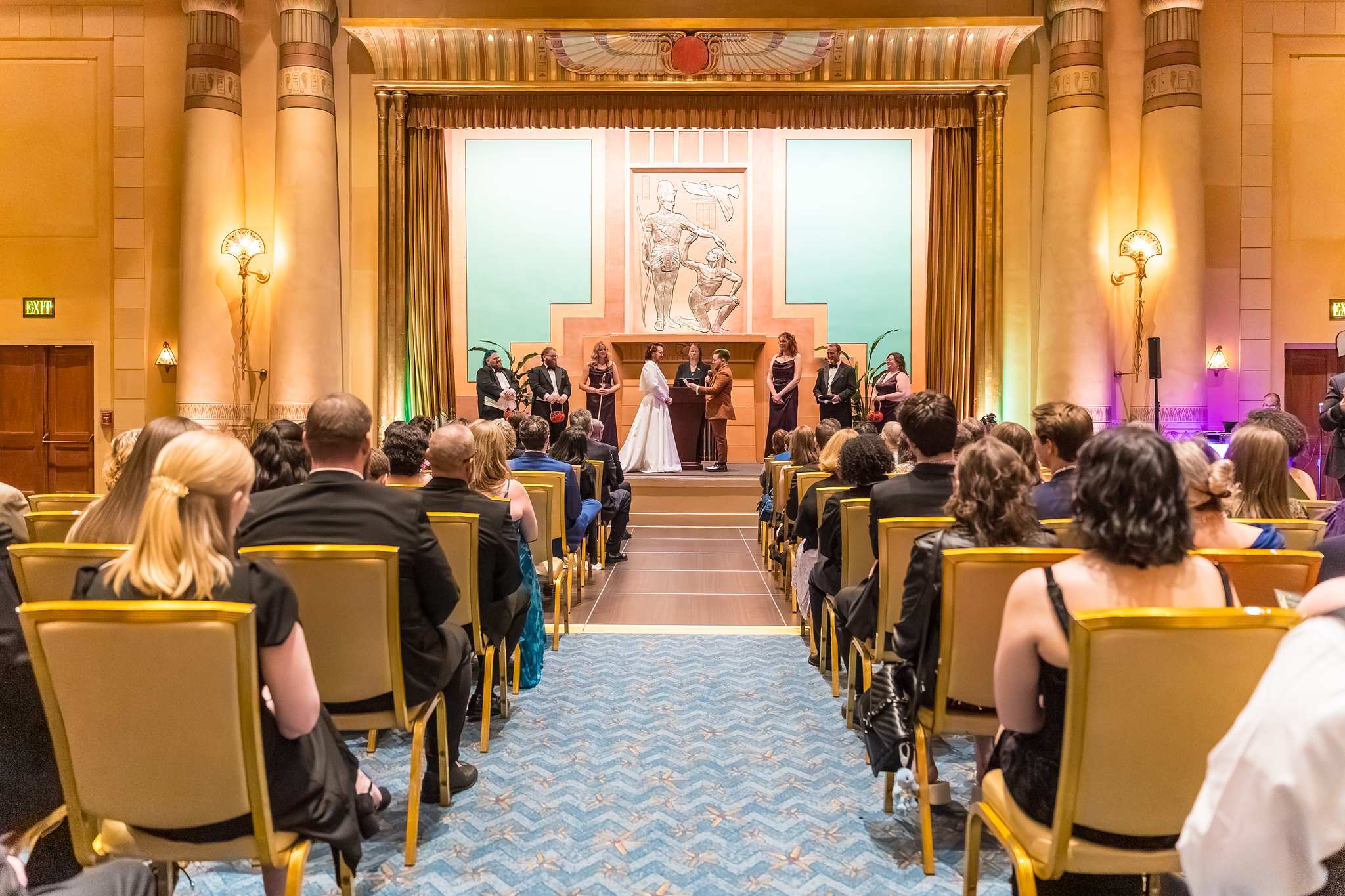 Wide view of a wedding ceremony in the Egyptian Ballroom at the Fox Theatre