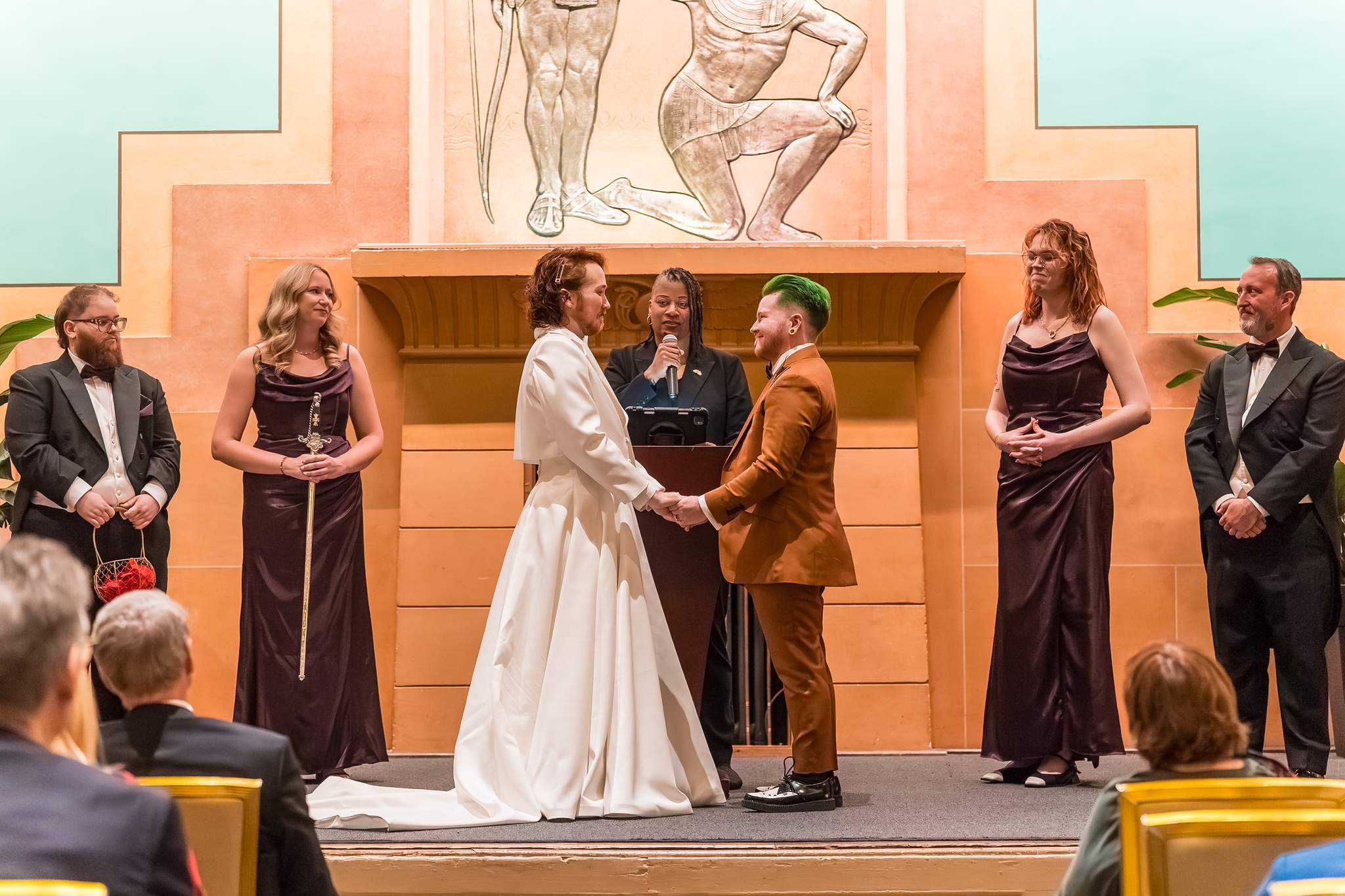 Couple holding hands during their Fox Theatre wedding ceremony