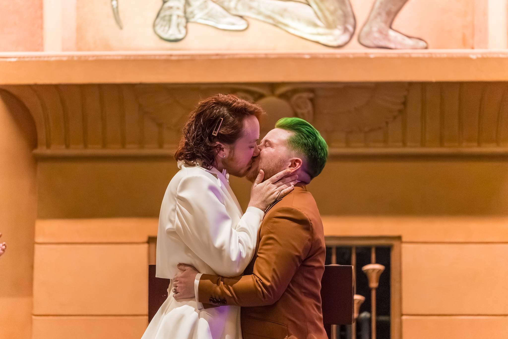 First kiss in front of the carved Egyptian Ballroom wall