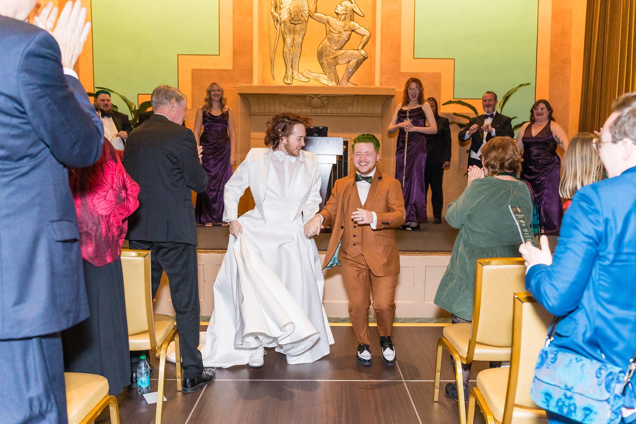 Couple celebrating as they walk back up the aisle after a Fox Theatre wedding ceremony