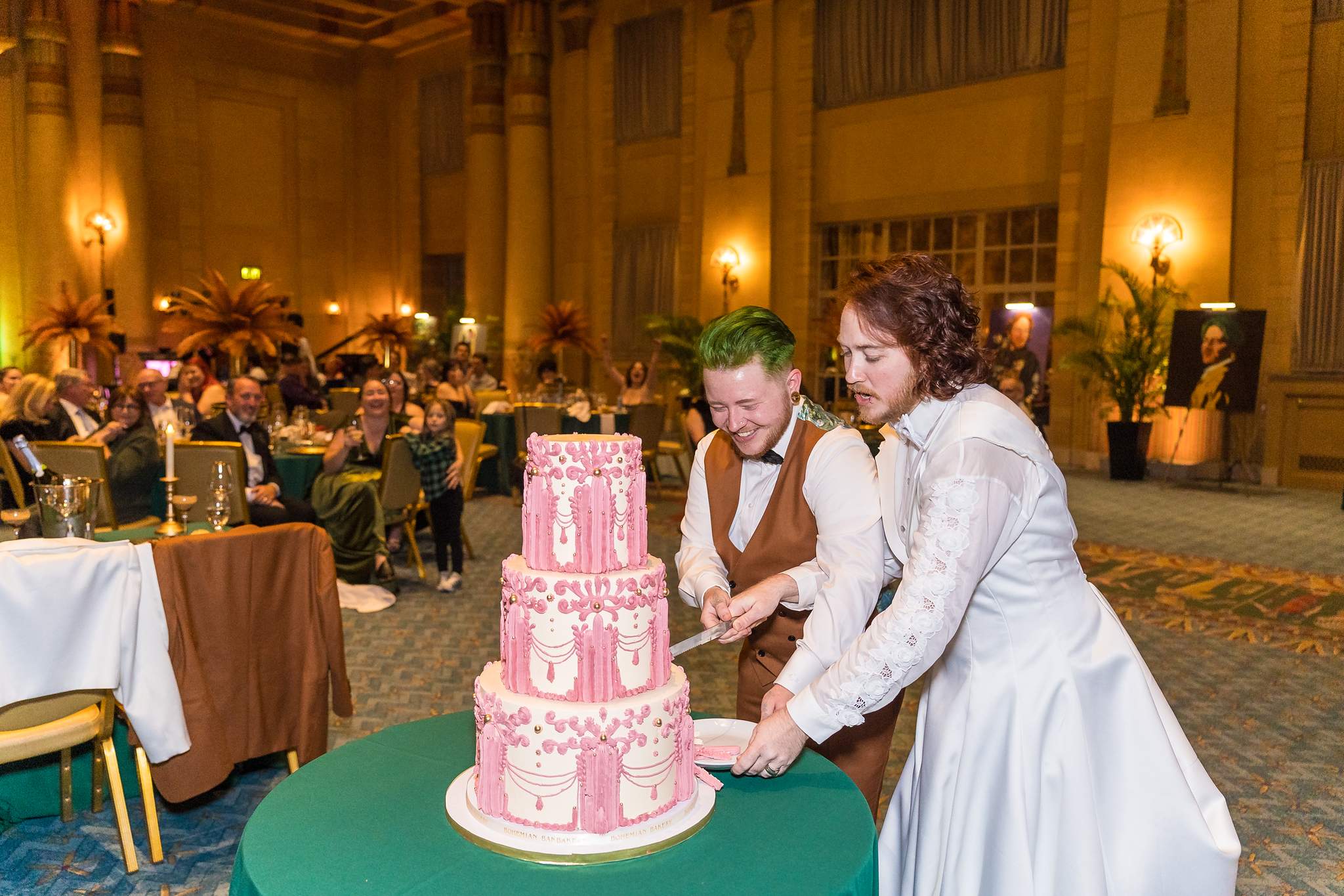 Couple cutting a pink wedding cake at a Fox Theatre wedding reception